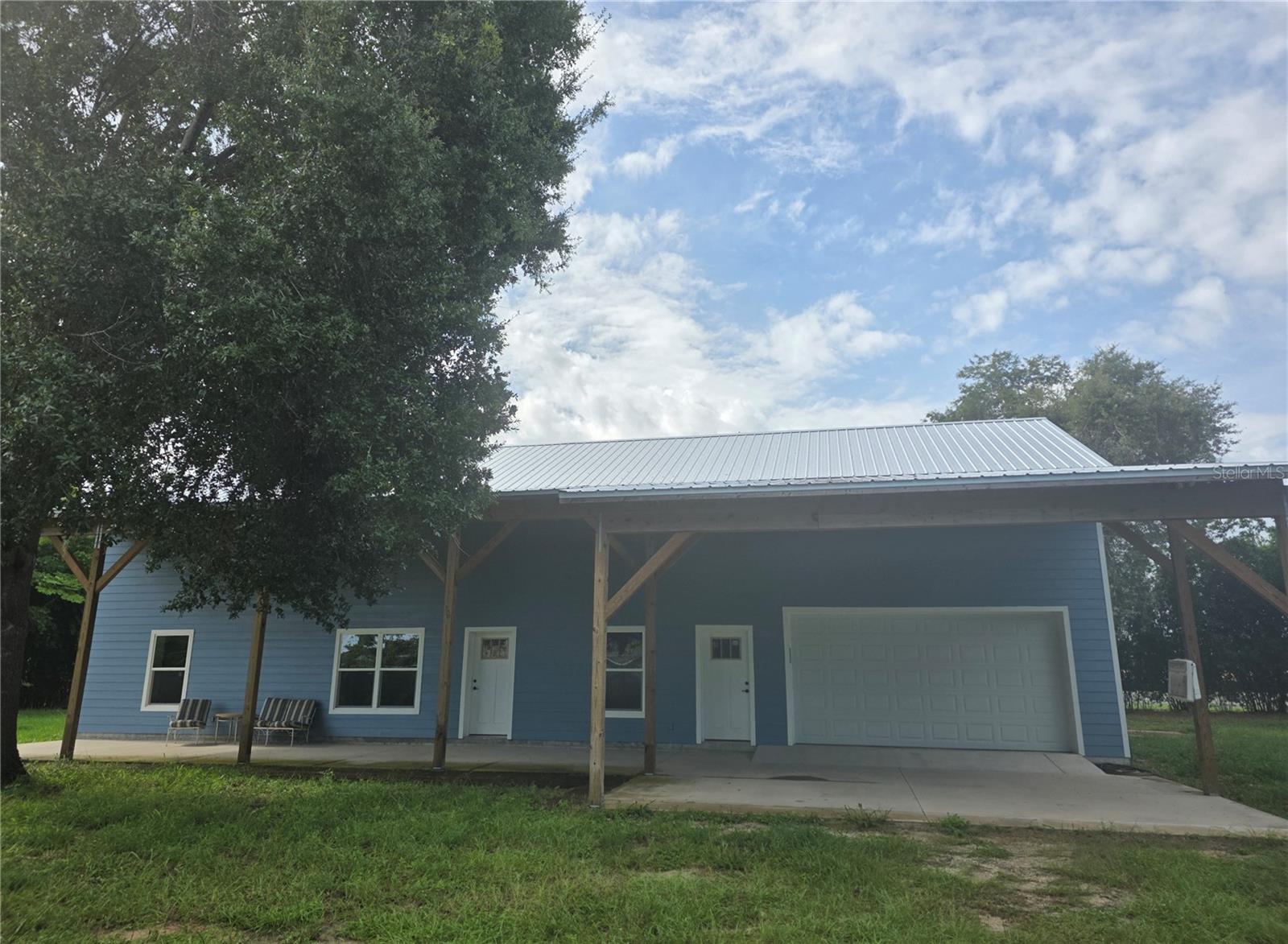 *Professional Photos Coming Soon* This spacious 2-bedroom 2 bath CUSTOM home sits on .65 acres nestled in the heart of Tavares, Florida. The home offers a blend of comfort and convenience. This unique property was built in 2024 using Insulated Concrete Forms (ICF), a construction system that provides an incredible combination of durability, strength and efficiency. ICF construction keeps the interior of this property warm in the winter and cool in the summer allowing your HVAC to operate at a minimum expense. LED lighting throughout the home contributes to further monthly savings. The Green Energy features of the home include the construction, insulation, windows and a dehumidifier system.
The spacious and oversized 2-car garage harbors an overhead Lift Master that is incredibly smooth and quiet with an auto locking feature for added security. There is also an additional storage room behind the garage that could be used as a workshop and/or storage for lawn equipment. Access to the 2nd level, which is under air, is through the garage via a 4’ wide staircase (no rickety pull-down stairs here) with subfloors over steel joists. The locally manufactured roof trusses are made of roll formed steel. There is no fiberglass insulation to worry about in this area either as the roof is insulated with closed cell foam further contributing to the efficiency of this property. In addition to storage, this area could also be used as a bonus or a media room. It’s a blank canvas for your imagination.
The exterior is clad with shiplap Crete board and painted in a beautiful Williamsburg blue with a light trim. Located in the front and rear of the home are tall open porches ready for relaxation. The property is completely fenced and has a private security gate. Another security feature installed is the 3-Point Deadbolt Locking System on all the exterior doors.
The interior of the home features 10’ ceilings throughout, a kitchen with 3’ wooden cabinets, a solid butcher block countertop, along with a Whirlpool stainless steel package. The primary bedroom is spacious and has 2 walk-in closets. Enter the primary bathroom and discover a large walk-in shower that hosts an incredible Rain Showerhead.
Don’t miss this opportunity to make this unique house your new home!