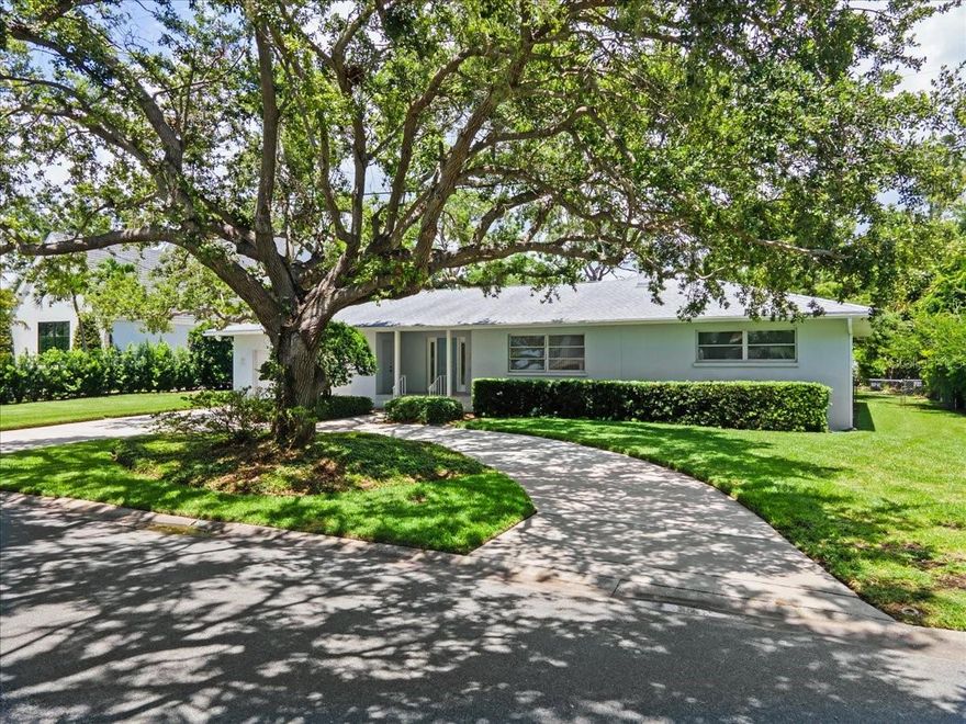 This unique home is in the desirable neighborhood of Harbor Acres. World renowned Selby Botanical Gardens is less than a mile from your new home. This mid-century jewel was built in 1956 and was originally a 2/2. The original bathrooms are still in their original state and are in good condition providing a cool retro vibe. The original hardwood floors and fireplace exude warmth and sophisticated charm.  The current owner purchased the home in 1989 and remodeled the kitchen and added a new wing on the house with 2 additional large bedrooms ensuite with baths. Copious amounts of storage in all 4 bedrooms and a huge laundry room with lots of closet space as well. The garage is oversize and there is a picturesque circular driveway for ample parking. There is plenty of room to put in a pool of your own design. The house was re-roofed in 2018. Some of the most beautiful homes in Sarasota are your neighbors in Harbor Acres. And Flower Drive is a special address with the highly sought after Southside Elementary School just 1-mile away, you can’t beat this property. In real estate it is all about Location, Location, Location. This home has plenty of room for the family, so, come on home!