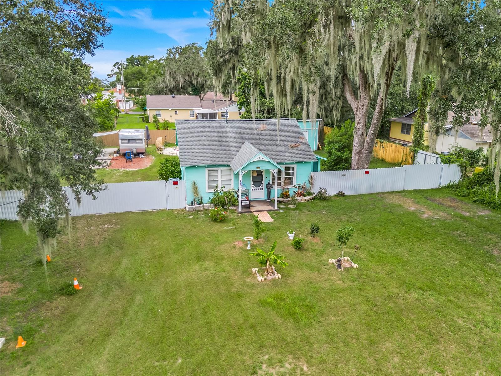 Discover a truly unique opportunity with this charming property! Nestled on a sprawling 100 x 130-foot lot, this R2-zoned gem is located in the heart of the picturesque historic downtown Mount Dora, right in the vibrant golf cart district. Currently, it boasts two delightful vacation rentals that capture the essence of relaxation and creativity. The first rental is an enchanting, artsy cottage, constructed with sturdy block and exuding a warm, inviting atmosphere. Inside, you’ll find two bedrooms and a lovely bonus room that currently serves as a dining area, perfect for sharing meals and memories. Recently updated, this cottage features stylish new flooring that complements its welcoming vibe, along with an open kitchen that beckons joyful gatherings. Step outside, and through a complete privacy fence, you’ll encounter a vintage camper on its own cement pad—an adventurous second vacation rental! This whimsical dwelling comes complete with its own fire pit, ideal for cozy evenings under the stars, as well as a delightful dining patio where you can grill your own BBQ meals. Don’t miss the unique "private outdoor shower," offering a refreshing escape after a day of outdoor fun. To add to the convenience, this camper is connected to its own public sewer line, and there's an additional hookup available for another RV—perfect for welcoming friends and family! A newly constructed storage building, measuring 12x24 feet, stands proudly on the property, fully permitted and ready to serve your storage needs. (approx cost 20k 2025) With no HOA constraints, you have the freedom to park your boat, and just a stone's throw away is the beautiful Gilbert Park—your launching point for exciting water adventures. Plus, you’ll love the convenience of being a couple of blocks from all the charming downtown shops and delightful restaurants that make Mount Dora special. For future investment, the R2 zoning should allow a fourplex to be built! Or your dream home right in the perfect location!! (was formerly two lots 30 & 31, buyer or buyers agent to verify with the city)