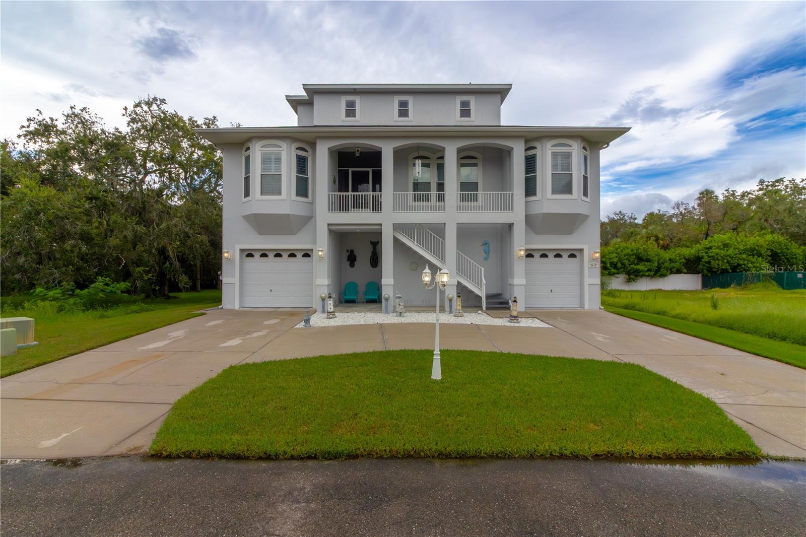 This custom-built Key West-style home in the gated Treasure Cove community offers nearly 3,000 sq ft of thoughtfully updated living space, featuring recent upgrades such as upper A/C (2024), lower A/C (2025), a new roof (Oct 2021), refinished wood floors (2024), new pool pump, new heat-cool pool heat pump (2025), and replacement of the left side entrance garage door (2025). The spectacular third-floor master suite includes a remodeled ensuite bath and private balcony. The second floor hosts three bedrooms, one currently being used as an office, formal and family living areas, and a covered balcony overlooking the pool. The gourmet kitchen boasts 4-year-old matching Samsung black stainless-steel appliances, solid wood cabinetry, and a breakfast nook.
The lower level features a game room with an included billiard table, a spa room ready for a new hot tub, and a split 4-car garage with a workshop area. The saltwater pool is enclosed in a private screened area. The lower garage area was affected by flooding during Hurricane Helene, but it has since been fully remediated and restored, including new patio doors in the game room leading to the pool area. Additional features include central vacuum systems, LiteTouch lighting control system, plantation shutters, and hurricane windows. Enjoy the privacy of the pool area and access to the community boat ramp for a true Florida lifestyle.