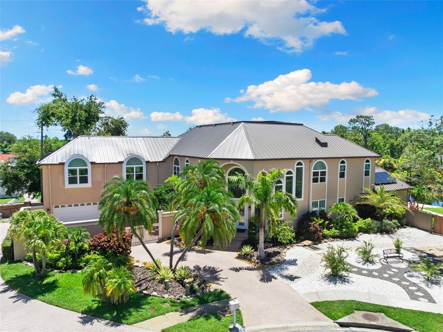 $300K Price Improvement! Over $1.2M in UPGRADES since 2022!

An extraordinary opportunity where luxury, paradise, prestige, and privacy unite. With over $1.2 million in UPGRADES since 2022, this remarkable estate delivers resort-style living, energy independence, and multigenerational flexibility in one of Clearwater’s most exclusive communities.

Set on 1.11 high-and-dry acres at the end of a quiet cul-de-sac within the private 11-home gated neighborhood of Landmark Reserve, this home showcases the highest quality systems and finishes. A bronze Galvalume standing seam metal roof (2022), fully paid 40.8 kW solar system with 125 SunPower panels and five battery backups, five HVAC systems (2022), and premium PGT hurricane-rated impact windows and garage doors ($350K upgrade in 2023) ensure unmatched durability and efficiency. Energy bills average just $35/month, supported by a Level 2 EV charger, water softener, and private irrigation well.

Inside, elegance is expressed through hardwood and marble tile flooring, coffered ceilings, custom millwork, and a sweeping imperial staircase beneath a statement crystal chandelier. The gourmet kitchen is equipped with a Wolf 6-burner gas cooktop, dual Wolf convection ovens, Sub-Zero refrigerator (2023), granite counters, oversized island, and custom cabinetry.

The main-floor primary suite offers spa-level luxury with a frameless walk-in shower with dual rain heads, soaking tub, double vanity, and direct outdoor access. A fully renovated guest apartment (2023) with its own kitchen, breakfast nook, living area, and laundry provides private space for guests, in-laws, or live-in support.

The outdoor setting is nothing short of a private resort: a heated saltwater pool and spa (2023) with travertine decking, sun shelf, LED lighting, water features, and a boulder rock fountain. A tranquil pond with a color-changing fountain is maintained by the HOA. The covered outdoor kitchen (2023) features a natural stone bar, gas grill, wet bar, built-in seating, and a private pool bath.

An adjacent lot is included, offering potential for an additional garage, guesthouse, or resale opportunity for a minimum 5,000 sq. ft. home.

Minutes from Clearwater Beach, Safety Harbor, Dunedin, airports, shopping, and fine dining, this estate offers an unmatched Florida lifestyle.

? A rare chance to acquire a modern, turn-key luxury estate with craftsmanship, energy efficiency, and privacy at its core. Properties of this caliber are seldom available—act quickly to make it yours. Don’t miss this rare opportunity. Be sure to check out the stunning social media reel attached.
