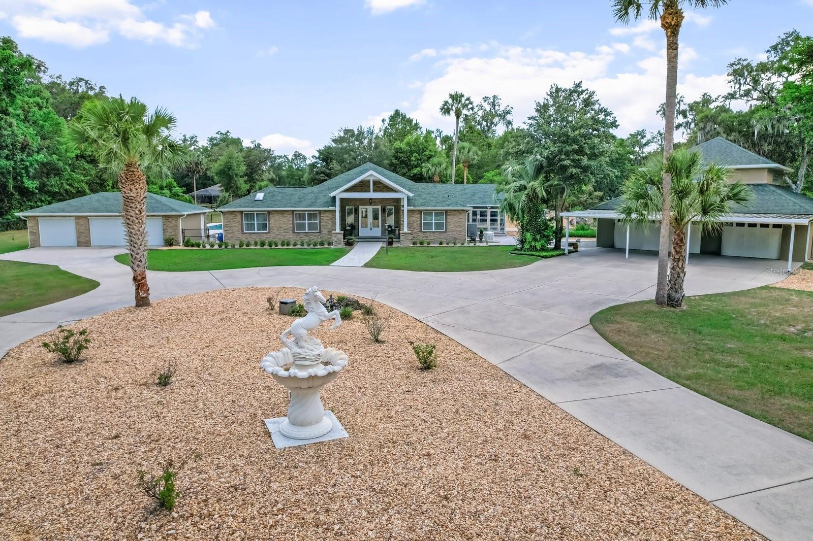 Priced BELOW recent appraisal! Whether you have a large or multi-generational family, frequent guests, or simply want the freedom to enjoy acreage, horses, or farm animals—this versatile 6-acre gated estate offers exceptional features and endless possibilities!
Set on the front 3 acres, the beautifully maintained home and grounds include a koi pond with waterfall, a 20x40 saltwater pool with LED lighting, lounge shelf, and ozonator, plus multiple garages: two 3-car garages (one with living space and full bath) and a 3-car carport. There’s also a 30x50 spray foam insulated barn with roll-up doors, a whole-house generator, and two gated entrances for added privacy and function.
Inside, you'll find 2 spacious master suites, an 18’ cathedral ceiling in the great room with fireplace, and a gourmet kitchen featuring a 4x10’ granite island, 6-burner gas cooktop, pot filler, GE Monogram double oven, dual dishwashers, built-in fridge, and a bar-style sunroom with nugget ice maker. The home also offers multiple utility rooms, impact glass, 3 instant water heaters, 4 high-efficiency A/C units, and cathedral ceilings throughout.
This one-of-a-kind estate blends comfort, functionality, and lifestyle in an ideal central location!