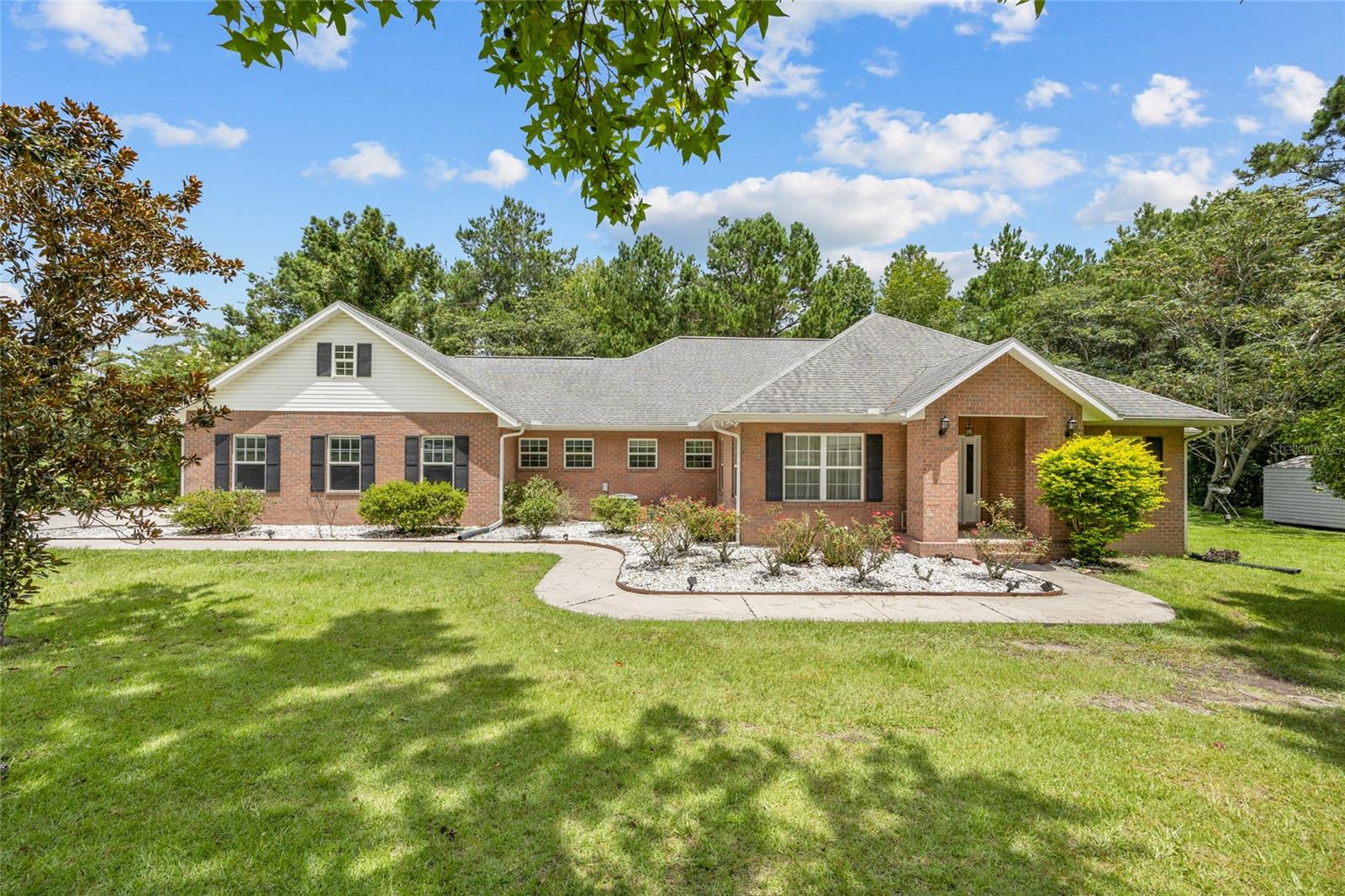 An immaculately maintained custom home nestled on 10 acres in a desirable homes-only community with paved roads. Step inside to discover quality craftsmanship throughout, including gleaming hardwood floors and a thoughtfully designed floor plan. The oversized master suite includes a cozy sitting area and luxurious en-suite bath, while two additional en-suite bedrooms offer privacy and comfort for family or guests. The cook's kitchen is a dream, featuring Corian countertops, double ovens, a center island, and an oversized walk-in pantry.
Additional features include a spacious laundry room with cabinetry, a formal dining room, an office/den combo, and a great room that flows effortlessly into the family room and interior lanai—ideal for relaxing or entertaining. Also an attached two car garage. Outside, the property is a great mix of woods and pasture, a livestock pond, and even a 100-yard gun range. The land consists of two separate 5-acre parcels, offering the potential to build an additional home. Perfectly situated for commuters, this private estate offers convenient access to I-75, just a short drive to both Lake City and Gainesville. This is a rare opportunity to own an elegant, well-designed home with acreage, privacy, and functionality—don’t miss it!