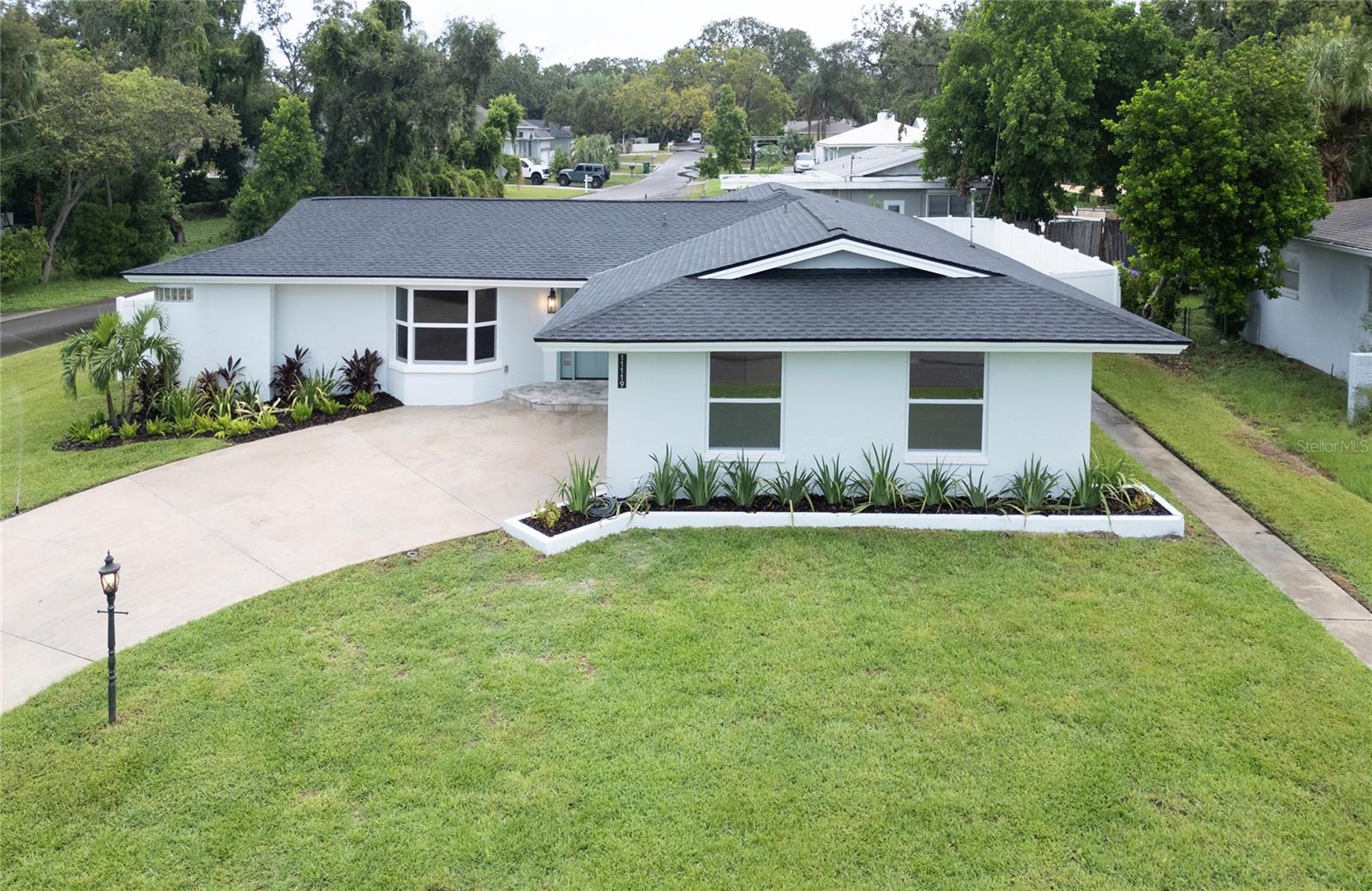 Welcome to this fully renovated Florida ranch, located just 1 mile from Florida Gulf Beaches in St. Petersburg. Situated on a spacious quarter-acre corner lot, it is outside the flood zone, in a non-evacuation area, with no damage from previous hurricanes —a rare combination this close to the Gulf.
The exterior has been completely updated with new sod, landscaping, irrigation system, roof, soffit, fascia, new white vinyl fence, new hurricane-impact windows, and hurricane-impact garage door with opener, along with fresh exterior paint. A fully fenced yard provides privacy, while the 300 sq. ft. paver patio creates the perfect space for outdoor entertaining.
Inside, the home lives like new construction, no one has occupied it since the top-to-bottom renovation. The redesigned open split-bedroom floor plan offers four bedrooms and two bathrooms, with just under 2,600 sq. ft of living space, not including a massive 650 sq. ft garage with plenty of room for your toys or a workshop. A large formal living room and formal dining room flow seamlessly into the open kitchen, anchored by a striking 14-foot island. The kitchen also features a dry bar with beverage fridge with custom wood shelves, stainless steel appliances, built-in drawer microwave, quartz counters, under cabinet lighting, crown molding and abundant storage and prep space.
The interior showcases engineered hardwood floors throughout, all new solid-core wood doors, new custom wood closet systems and closet doors, new trim, new hardware, new lighting, new electrical outlets, new rocker switches/dimmers and fresh paint. Each bedroom is outfitted with a custom wood closet system, including a 12x6 custom built wood wrap around closet system in the master suite.
The master retreat includes 2 large windows with tons of natural light, a large custom built walk-in closet, an en suite bath with dual vanities, LED lighted mirror, a glass-enclosed shower with marble and mosaic tile, and two shower heads—one rain shower and one standard. The guest bath is equally impressive, boasting custom tile work, dual-sink vanity, gold fixtures, sconces, a bathtub, and a private toilet closet. Additional highlights include new French doors, new ceiling fans, upgraded hardware, and a dedicated laundry room with wash sink, quartz counters, and built-in cabinetry.
This home combines the charm of a classic ranch with the peace of mind of a full modern rebuild. Its prime location places you just minutes from the best Beaches on the West Coast of Florida, local shops, dining, and vibrant Gulf Coast living, all while enjoying a quiet residential neighborhood.