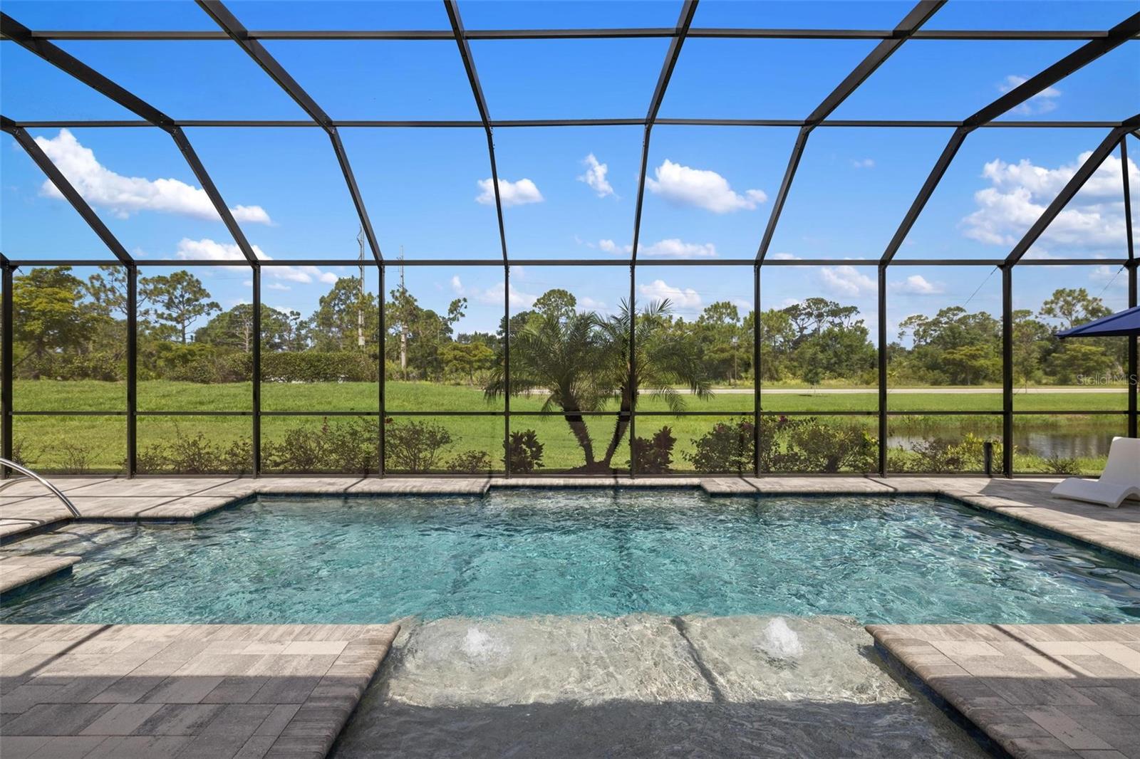 Enjoy the Ultimate Wellen Park Lifestyle — Including a Free Massage for the Buyers!
Experience true resort-style living in Gran Paradiso, where your new home purchase comes with a free massage from the community’s on-site massage therapist—the perfect way to start enjoying your new Florida lifestyle from day one. More than a neighborhood, Gran Paradiso is a way of life. One of the only communities in the area to offer such an impressive collection of amenities, residents enjoy pickleball and tennis courts, a full-time lifestyle director, sauna, on-site personal trainer, on-site gym, and massage therapy—all just a bike ride away from Downtown Wellen Park. From sunrise fitness classes to sunset concerts, every day feels like a resort retreat.
Discover refined Florida living in this beautifully upgraded Oakmont II model located in the sought-after gated community of Gran Paradiso in Wellen Park. This 4-bedroom, 2.5-bath, 3-car-garage home showcases a radiant open-concept layout designed for comfort, style, and effortless entertaining. The chef’s kitchen is a true showpiece—featuring timeless white cabinetry, granite countertops, and a full suite of GE Profile stainless steel appliances that blend high-end performance with everyday functionality. Whether preparing a casual meal or hosting family and friends, this kitchen is as practical as it is elegant.
The primary suite offers a serene retreat with a spacious seating area, a well-appointed walk-in closet with custom built-ins, and a luxurious en-suite bath featuring a deep soaking tub and Roman-style walk-in shower. Bedroom #4 offers flexibility as a home office, study, or creative space, and the dedicated pool bath is perfectly positioned for guests enjoying the outdoors. Outside, unwind beneath the impressive 10.5-foot-tall pool enclosure, built with top-tier materials for durability and clear pond views. With a rear western exposure, the home is perfectly positioned to enjoy breathtaking Florida sunsets from the privacy of your heated saltwater pool and sun shelf. Whether hosting guests or savoring a quiet evening, the setting is nothing short of spectacular.
A motorized hurricane screen, retractable front door screen, reverse osmosis system, and whole-home water filtration offer convenience and peace of mind. The garage is fully insulated, enhancing energy efficiency and comfort year-round—ideal for a home gym, hobby space, or protecting your vehicles from Florida’s summer heat. Lush, mature landscaping and elegant paver walkways complete the picture of refined curb appeal.
From your doorstep, walk or ride your golf cart to Downtown Wellen Park, where weekends come alive with live music on the Solis Stage, weekly Farmers Markets, brunch at Oak & Stone, coffee at Foxtail, and outdoor yoga or Zumba on the Canopy Green. It’s the perfect balance of luxury, convenience, and community. Residents of Gran Paradiso enjoy resort-style amenities including a clubhouse, on-site gym, sauna, basketball, on-site massage therapy, tennis and pickleball courts, a full-time lifestyle director, and a stunning beach-entry resort pool—just minutes from CoolToday Park, championship golf, and the beautiful beaches of Venice.
Don’t miss your chance to own this incredible Florida oasis—come live the sunset-filled lifestyle you’ve been dreaming of before it’s gone!
