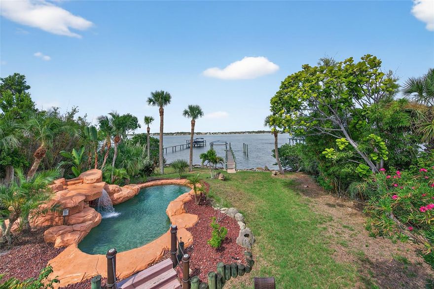 Waterfront living on the Halifax River with sunsets, dolphins, and your own dock and boatlift as the backdrop.

This 5-bedroom, 5-bath home offers plenty of space with a great room featuring vaulted ceilings, a statement staircase, and iron balcony details. You’ll also find a dedicated office, game room, and multiple living areas.

The kitchen is built for function and entertaining, with a layout that works for more than one cook. Upstairs, the primary suite includes a private riverfront balcony with direct access to the backyard. A separate downstairs suite is ideal for guests, in-laws, or teens.

Out back: freeform pool, tropical landscaping, waterfall with a grotto, and a brick paver patio with wet bar—all overlooking the river and your own private dock.

If you want a home that actually feels like Florida, this is it, and just 3 minutes from beach access.