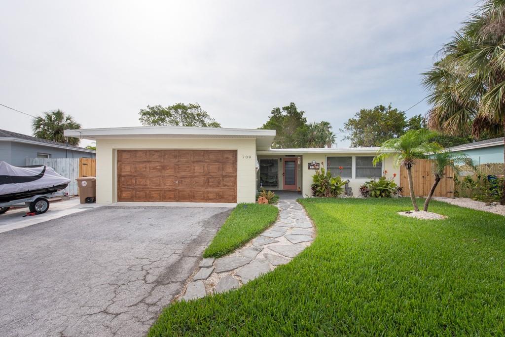 Welcome to this amazing beach home located in the beautiful city of Madeira Beach, Florida. If you are a water enthusiast, then this is the perfect place for you! Just across the street, you will find a boat launch, a shuffleboard court, and a fishing dock where you can spend endless hours of fun and entertainment, making it an absolute paradise for boating and fishing enthusiasts. This property also offers the option of joining the Homeowners Association (HOA), which provides access to paddle boarding and kayaking; they do have usable kayaks on site, ideal for those who love to explore the sparkling waters of the Gulf. Inside the home, the soaring cathedral ceilings and elegant ceramic tile flooring create a warm and inviting atmosphere that exudes comfort and style. The open living space is perfect for entertaining guests or spending quality time with loved ones, and a small office is conveniently located nearby for those who need to work from home. The upgraded galley kitchen features plenty of storage space and a window that overlooks the open porch, providing breathtaking views of the surrounding neighborhood. Both bedrooms are spacious and come with built-in closets, offering ample storage for all your belongings. The expansive fenced backyard is an absolute delight, complete with a pavered area, hot tub, gazebo, and storage shed. Perfect for hosting barbeques, outdoor parties, or simply relaxing under the warm Florida sun, this backyard oasis is sure to impress. To top it all off, this property also comes with a 2-car garage, providing plenty of space to park your vehicles and store your beach gear. So why wait? Schedule your tour today and experience the Florida beach lifestyle at its finest!