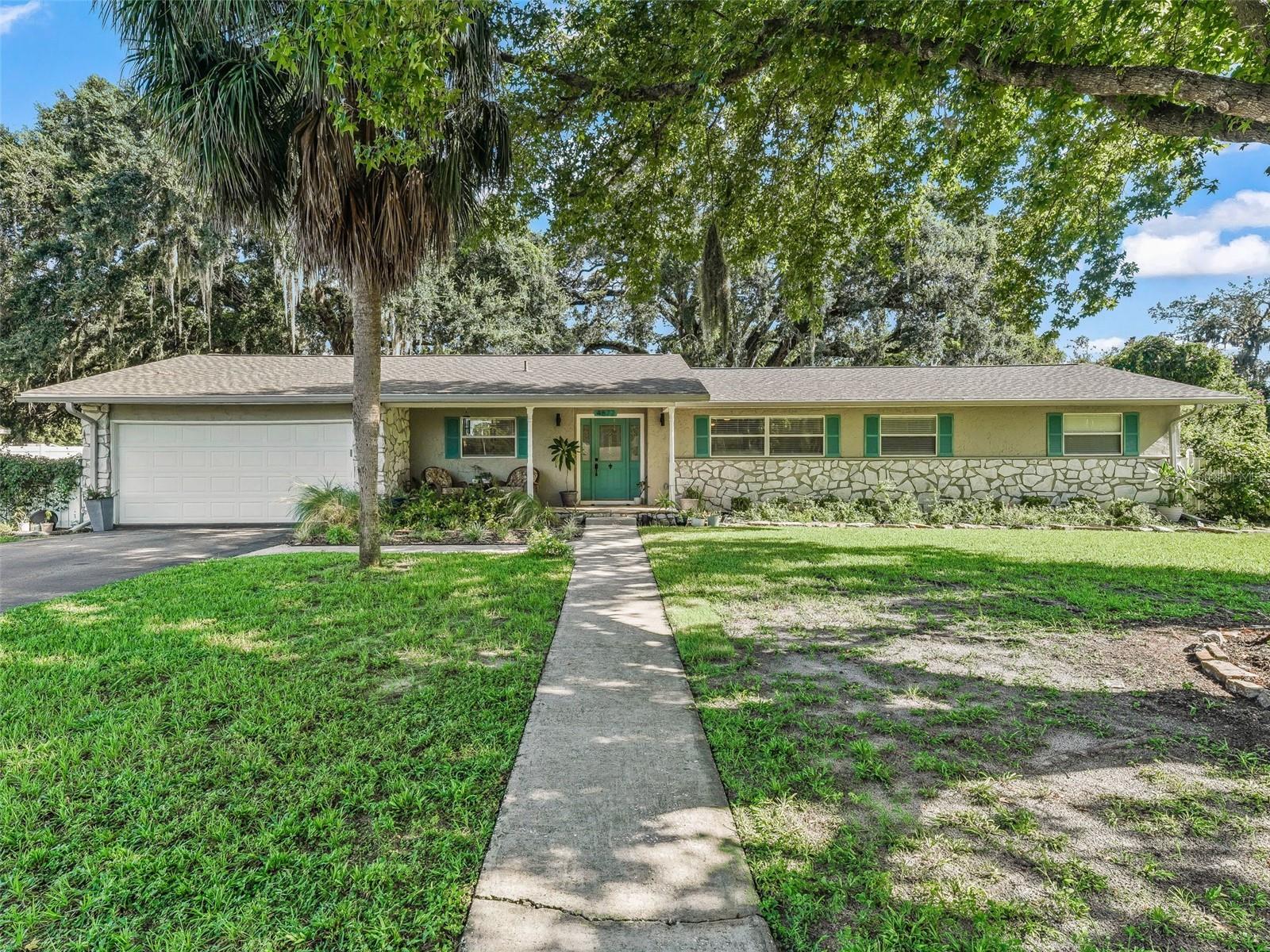 Welcome home to this beautifully maintained 3-bedroom, 2-bath ranch offering just over 1,600 square feet of thoughtfully designed living space. The heart of the home is the modern kitchen featuring sleek quartz countertops, a classic subway tile backsplash, and a nice center island that overlooks the open-concept living and dining area—perfect for entertaining or casual everyday living. Enjoy the durability and warmth of laminate flooring throughout the main living areas and bedrooms, while having tile in both bathrooms. All three bedrooms are conveniently located down the hall, providing a quiet and private retreat. Step outside through sliding glass doors onto the large screened lanai—ideal for morning coffee, evening relaxation, or hosting guests while overlooking your spacious and shaded backyard. This home combines style, functionality, and comfort in a layout that truly works. Don’t miss the opportunity to make it yours!