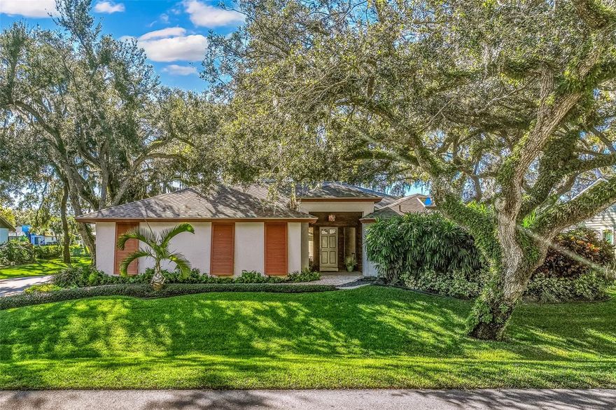 One or more photo(s) has been virtually staged. Discover this stunning three-bedroom, two-and-a-half-bath home nestled on a quiet street in the sought-after Sherwood Forest community. Set on a spacious, beautifully treed lakefront lot, this residence combines serene natural surroundings with elegant modern living.
Step inside to find neutral-toned engineered hardwood floors flowing throughout the home, complemented by custom cabinetry and built-ins thoughtfully placed in several rooms. At the heart of the living space, a double-sided gas fireplace set in striking Coral Stone creates a warm and inviting ambiance.
The upgraded kitchen features premium Bosch and Samsung appliances, abundant storage, and a charming built-in seat bench and table for casual dining. The luxurious primary suite offers his-and-hers walk-in closets and a spa-inspired bathroom with double sinks and generous storage solutions.
Outdoor living is equally impressive, featuring a fully equipped outdoor kitchen with a custom granite bar, cable TV, and a Sonos sound system that extends through the family room, primary bedroom, and lanai—perfect for entertaining or relaxing lakeside. Hurricane Shutters for some of the windows in the home. Roof replaced in 2018. Gorgeous landscaping with Sand Oak Trees, irrigation to keep your St. Augustine lawn pristine.  Paver pool area, driveway and walkways.
Great central location in town! Not many communities have the larger lots, majestic oaks and winding roads that Sherwood Forest exudes. Enjoy shopping, dining, beaches, the arts and so much more that Sarasota has to offer.
A rare opportunity to own a refined home blending comfort, craftsmanship, and lakefront tranquility.