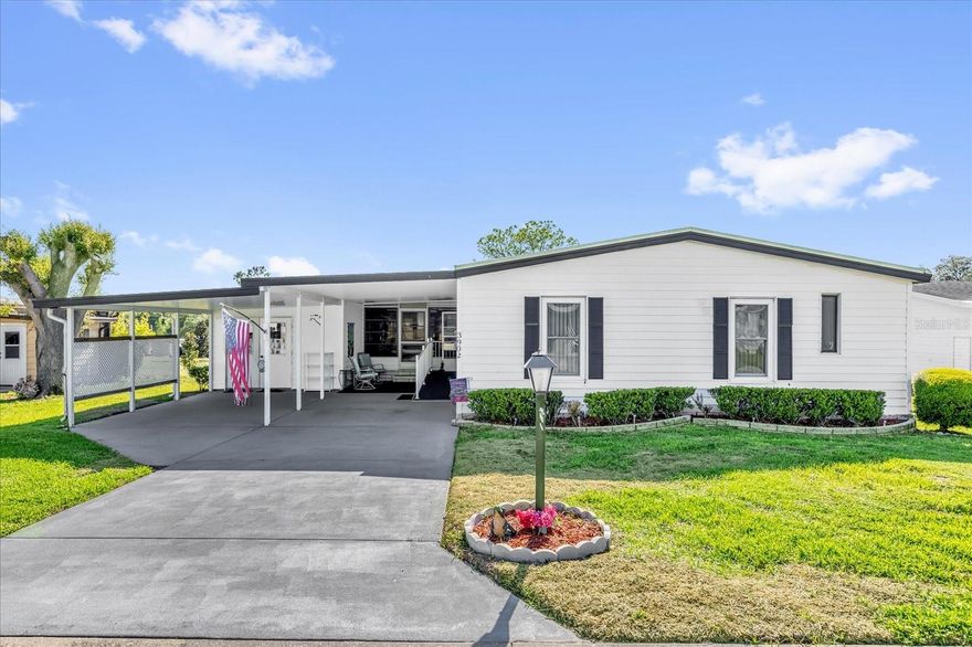 Gorgeous 2/2 On 18th Green/Fairway. Spectacular views from 27x18 Living Room and 12x17 Florida Room. Spacious floorplan ready for your personal touches. 2016 Membrane roof on Main Home plus 2021 Carport/Porch re-roof, 2014 A/C well-maintained. Newer windows in Living/Dining Area and vinyl all-season windows in the Florida Room. Desirable Double Carport and Golf Cart Garage/Storage. Tons of cabinet space in the Kitchen and Inside Laundry. Extra Refrigerator conveys. Located in Prestigious 55 Plus Zellwood Station Golfing Community. More amenities and activities than you can fit into your busy lifestyle. Close to shopping, restaurants, airports, beaches, places of worship, theme parks. 4 Pools, Pickleball, Tennis, Shuffleboard, Bingo, Trivia, Cornhole, Stained Glass, Ceramics, Exercise. Woodshop, RV Parking, FULL SERVICE RESTURANT/BAR ON SITE, 18 Hole Gold Course with Reduced Greens Fees for Shareholders.