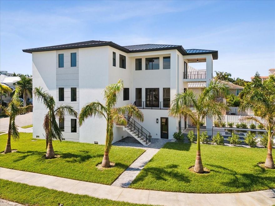 One or more photo(s) has been virtually staged. Discover your dream home in the exclusive Redington Shores Yacht and Tennis Club! This magnificent contemporary residence features four spacious bedrooms, each with its own ensuite bathroom. The expansive kitchen is a culinary haven, equipped with Wolf appliances, and a striking island, while the airy large living room, is perfect for entertaining.

Enjoy seamless access to all levels of the home with a convenient elevator. Additional features include a spacious loft, a generous laundry room, a large storage area, walk-in closets in every bedroom, and a well-sized pantry.

Embrace outdoor living on the expansive porch and patios, and unwind in the inviting heated pool with a hot tub. For those who love boating, a boat dock is available at an additional cost. The property also includes a five-car garage, providing ample parking and storage solutions.

Located within a secure, 24-hour guard-gated community, residents enjoy access to tennis courts, a community pool, and a clubhouse complete with a fitness center and an area for your meetings. This exquisite home won't last long—schedule your viewing today!