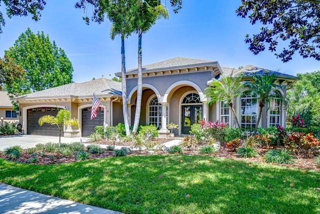 Experience the perfect fusion of luxury, elegance, and craftsmanship in this custom-designed Arthur Rutenberg home, ideally situated in the coveted GATED waterfront enclave of Pasco Sunset Lakes. Tucked away on a tranquil 0.38-acre private conservation homesite, this residence offers a lush backyard oasis and serene marsh views beyond. Outdoor living shines with a sparkling pool, dedicated pool bath, screened lanai, outdoor shower, and a stunning multi-level paver patio with a built-in stone firepit—an idyllic setting for entertaining or unwinding beneath the stars. Impeccable curb appeal is delivered by manicured landscaping, a stately portico entrance, architectural columns, and elegant bay windows. Step through 8-foot double glass doors crowned by an arched transom window into a grand tiled foyer, where a decorative floor medallion and double tray ceiling set the tone for the home’s refined interiors. A pony wall stylishly separates the formal dining room, appointed with its own tray ceiling, crown molding, custom built-in display unit, and custom arched window with Plantation shutters. The living room echoes this elegance with a stacked stone accent wall featuring an electric fireplace, double tray ceiling, crown molding, and triple windows framing views of the lanai and conservation beyond. The gourmet kitchen caters to culinary enthusiasts with a full suite of stainless appliances —including a gas range with double oven—granite countertops, tile backsplash, a center island hi-breakfast counter with pendant lighting, and tall raised panel wood cabinets with crown molding. A walk-in pantry, built-in desk space, and a café-style dining area with bay windows overlooking the lanai and pool complete this space. Designed for gatherings, the family room with a built-in entertainment center, paddle fan, and sliding glass doors seamlessly extend living space outdoors. A versatile bonus room features a tray ceiling, abundant natural light, sliding glass doors to the pool area, and comes complete with a pool table and window coverings. Retreat to the luxurious primary suite, where a double tray ceiling with crown molding, bay windows, lanai access, and two large custom walk-in closets create a private haven. The spa-like ensuite bath offers a garden tub, walk-in shower, private water closet, and dual vanities—one with a make-up area.
Step outside to your private oasis, where the screened lanai (re-screened 2024) and beautifully designed paver pool deck set the stage for resort-style living. Enjoy a refreshing pool (pump replaced 2017) and an impressive outdoor kitchen set against a striking stone wall, complete with a built-in gas grill, vent hood, sink, refrigerator, ample counter space, and a generous dining area—perfect for alfresco entertaining. Just beyond, the multi-tiered paver patio is an ideal setting for outdoor gatherings, evening cocktails, or lively celebrations under the stars.
Notable upgrades include a roof, replaced 2017, HVAC installed 2019, and a central vacuum system. Located in a golf-cart-friendly community offering a wealth of amenities, this well-maintained home presents a rare opportunity you won’t want to miss. Schedule your private tour today and experience the lifestyle that awaits!