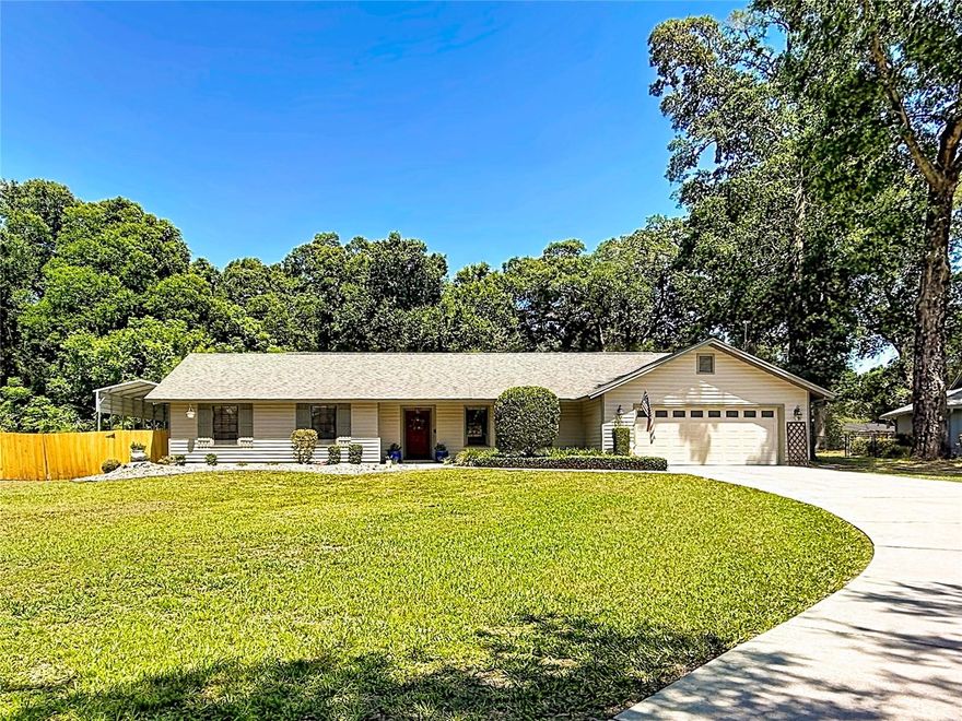 The birds are ah chirping on 69th Terrace!  As you wind your way up the large driveway take in the mature landscape and large oak trees that outline the perimeter of this large .50 acre property.  Take a step into this charming 3 bedroom 2 bathroom ranch style pool home and you will find a wide open floorplan including plenty of natural light.  As you make your way through this home you will find hardwood floors, ceramic tile, colonial baseboards, large windows and granite countertops that give this home a warm and welcoming feel.  The dining room, kitchen and nook will provide ample space for entertaining while you prepare your favorite dishes for guests.  Large indoor laundry room features washer, dryer and built in folding bench to make laundry a breeze.  Make your way down the hall and find the guest bathroom with tile shower, granite tops, wainscoting with plenty of hooks for your pool towels after those hot summer swims.  Spacious guest bedrooms are next including crown molding and slider closets.  The master suite features his and her closets, wood flooring and connecting bathroom with exterior door access to the back patio pool and spa.  Walk out into the screened in Lanai and enjoy your morning coffee or favorite beverage at the wet bar with granite tops, sink, mini fridge and outdoor cabinet space.  Move out to the pool patio and fire up the grill for dinner or host your friends for a BBQ get together you choose.  The large backyard includes more mature landscaping, a firepit and plenty of space for all your outdoor activities.  Oversized shed in the rear for all your landscaping storage needs or perfect for a workshop.  Backyard also includes a 34x12x12 covered carport for your RV or boat.  Oversize 2 car garage includes built in work bench and plenty of storage for all your needs.  Come out and take a look at all this property has to enjoy.