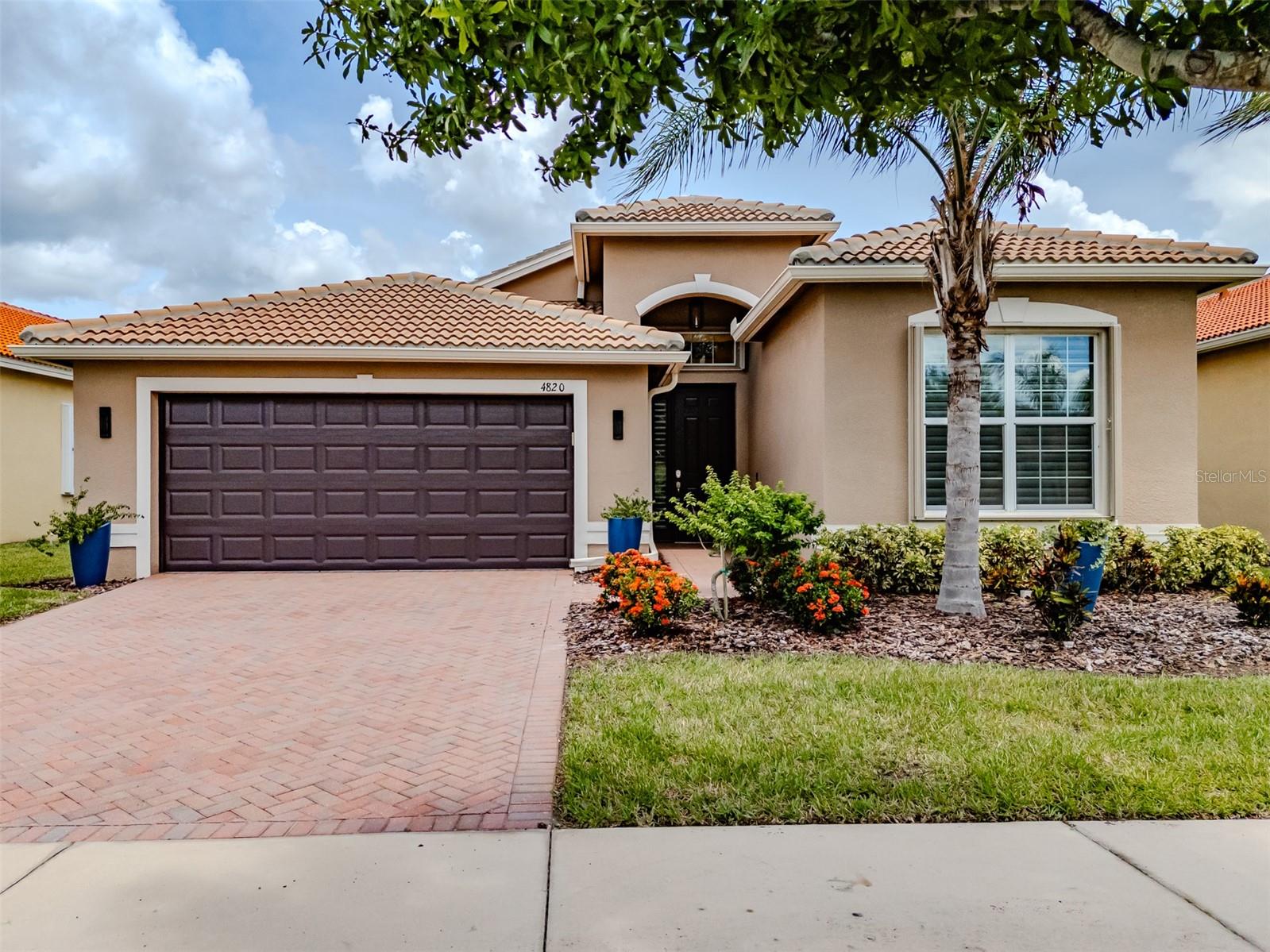 Seize the day! This beautiful GENOVA is now available in Valencia Lakes, Tampa Bay's premier 55+ Active Adult Community. Built in 2018, this GENOVA is 2,107SF under air, and features 2 Bedrooms, an Office, 2 full Bathrooms, an expansive 18’ x 15’ Great Room, Chef's Kitchen, Dining Room, Dinette, an L-shaped screened in Lanai and a 2-car Garage. As you enter, you will be welcomed into a large Foyer with a 14'-to-'15' tray ceiling and gorgeous engineered hardwood flooring throughout, save for the wet areas. Right of the Foyer and at the front of the home is the Guest Bedroom with a double closet and Hunter-Douglas shades offering your guests comfort and privacy. The Guest Bathroom features a with a walk-in shower, granite countertops, and the window has privacy glass. The Laundry Room offers an LG Washer and Dryer, a cabinet utility sink, lower cabinets and storage racks above. Forward of the Foyer is the inviting open floorplan. The Dining Room features a Cosmopolitan Linear chandelier and will comfortably accommodate 8 persons. The Chef’s Kitchen features stainless-steel appliances, a double-sink with a RO faucet, Pantry, 42” solid-wood chiffon white cabinetry capped by granite counters and a glass subway tile backsplash. Just off the kitchen, the Dinette is a great spot to enjoy a leisurely meal and has access to the lanai via two sliding glass doors. The 15’x18’ Great Room features a 60” Minka ceiling fan and it feels expansive and cozy at the same time. Abundant windows and a 4-panel 12’ sliding-glass door leads to the Lanai providing a bright living space when desired and the custom Hunter-Douglas silhouette shades ensure privacy. The sprawling L-shaped Lanai with 2 ceilings fans allows you to bring the outdoors, indoors. The Primary Bedroom with Ensuite Bathroom is at the rear of the home. It is 20’x13’ with a 10’-to-11’ tray ceiling and has three windows, two walk-in closets, one is finished, and a wonderful Ensuite Bathroom. The Ensuite Bathroom features 18”x18” porcelain tile on the diagonal, separated vanities with granite counters, a Roman Bathtub, a large Walk-In Shower and a Water Closet for the Commode. The home’s interior has been freshly painted throughout. The 2-car Garage has exquisite epoxy flooring, an insulated door powered by a quiet belt-drive opener, a 4’x8’overhead storage racks and three additional wall-mounted storage racks. Interior environmental comforts are assured by a RUUD HVAC (2021). The exterior features Accordion Hurricane Shutters on all openings, and whole-home Gutters. Valencia Lakes is an amazing community that has a 40,000SF Clubhouse offering entertainment shows, dances, myriad clubs, a state-of-the heart 24/7 Fitness Center, resort-style pool, lap pool, two multi-purpose fitness studios, card rooms, craft rooms, pickleball, tennis and much more. Conveniently located near two new hospitals, the brand new Moffit Cancer Center, Downtown Tampa, Tampa airport, and a short drive to Disney, Cruise Ports, Sarasota and some of the best beaches in the country! Seize the day and begin living your idyllic life in this special home.