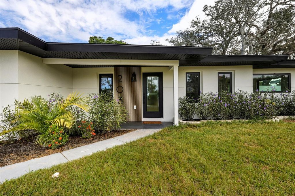 Photo of 203 Driftwood Drive W, Palm Harbor, FL 34683 (MLS # TB8403059)