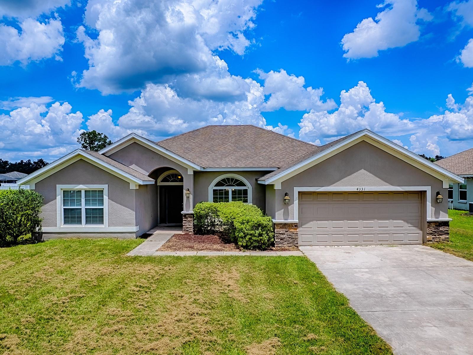 Imagine yourself in the serene oasis of Magnolia Pointe, a gated community that offers the perfect blend of seclusion and convenience, just outside of the hustle and bustle of town. This stunning home, situated on a quiet cul-de-sac street, boasts a private setting, backed by a retention area, ensuring a peaceful atmosphere.
The grand entrance, featuring a beautifully designed front elevation with stone detail, sets the tone for the elegance within. The two-car garage and tiled foyer entry invite you to come inside, where the front door, adorned with double sidelights and a top transom window, allows an abundance of natural light to pour in.
Inside, the vaulted ceilings and plant shelves create a sense of openness, while the cozy carpet throughout (except in the wet areas, where tile is used) adds warmth and comfort. The split bedroom plan ensures a peaceful retreat, with the primary suite offering a serene escape.
The expansive kitchen is a culinary haven, featuring an eat-at bartop, stainless steel appliances, and recessed lighting that creates a warm and inviting atmosphere. Prepare meals and enjoy dining in the kitchen, breakfast nook, or formal dining room - the options are endless.
The primary suite is a serene retreat, with a tray ceiling framed with crown molding, and a beautifully appointed bathroom featuring a soaking tub, wavy block window, glassed shower, dual vanity, and separate water closet. The other three bedrooms are generously sized, with walk-in closets behind designer doors, and an additional bathroom on the guest side, complete with a shower.
Out onto the covered lanai, you'll be treated to great views of the large, privacy-fenced rear yard, perfect for outdoor entertaining, relaxation, or simply enjoying the fresh air. Whether you're looking for a peaceful retreat or an entertaining paradise, this Magnolia Pointe home has it all.
With its perfect blend of style, comfort, and practicality, this home is the perfect haven for anyone seeking a serene and luxurious lifestyle. Come and experience it for yourself!