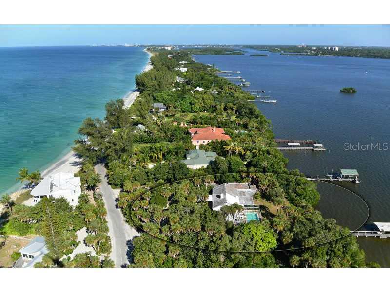 The list price includes two separate parcels. Choose to build as two home sites with a home and separate garage on each or combine the parcels as one with a total Bay frontage of 200' and a homesite of over one acre. Owner has a Letter of Determination from Sarasota County. Situated on one of the higher elevations available on Casey Key, the current home on one parcel is true Old Florida charm. Built in 1937, this bungalow design features Pecky Cypress wood in the living and dining room, along with two fireplaces in the living and owner's suite. Uniquely available, this home provides walk in attic space with a full cedar clothing closet. You will truly revel in the views to the Bay while in the home or pool area and enjoy the heavily landscaped privacy from your neighbors. The covered boat dock reaches out to provide an amazing view of the Bay, Black Burn Point Bridge and beyond. Take advantage of this rare opportunity of location, land size and flexibility, elevation, mature landscaping and views. It truly is a diamond in disguise waiting for your choice renovation or your own dream home. Make sure you take the time to watch the aerial video virtual tour. It allows you to appreciate this amazing opportunity!