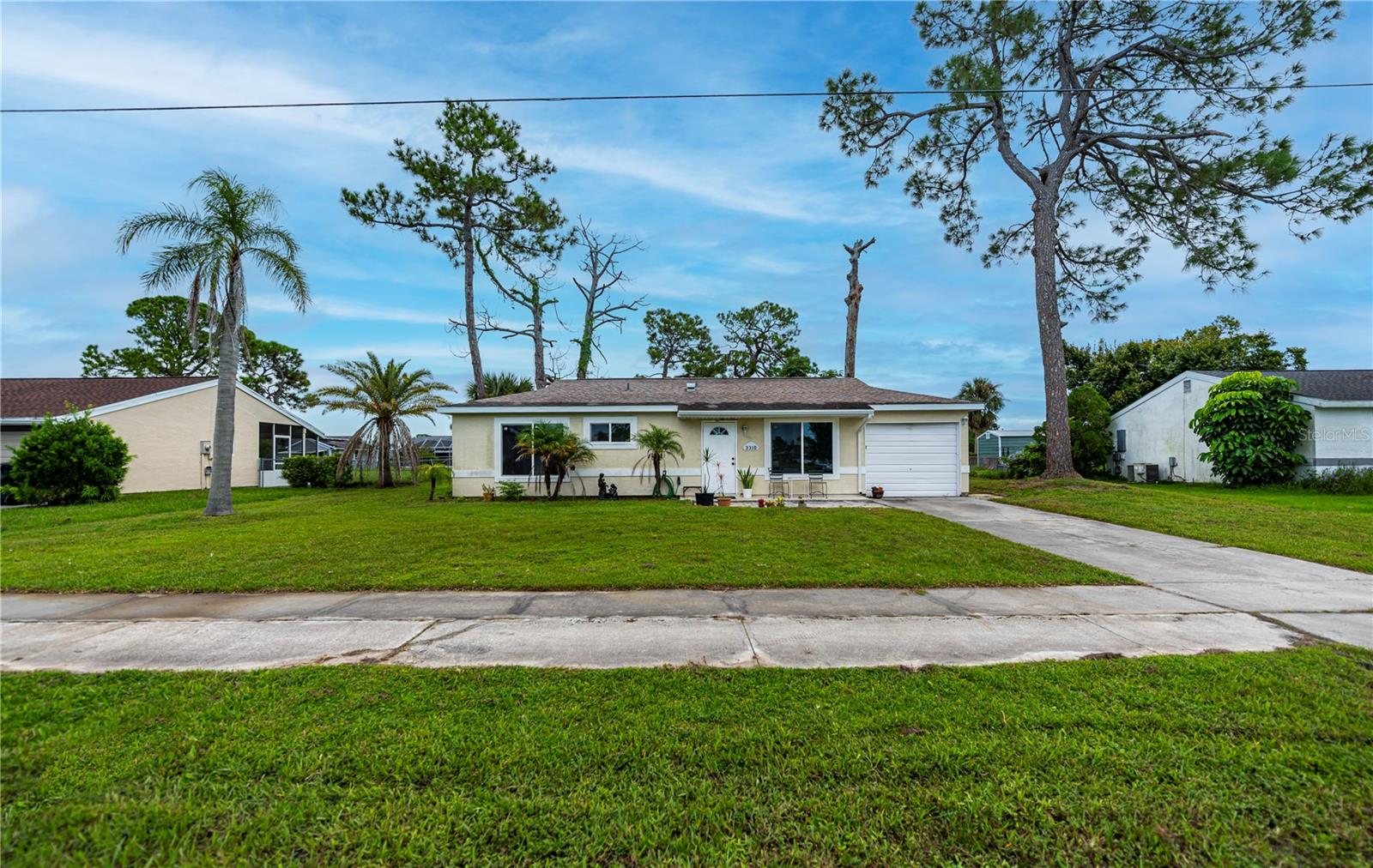 Fantastic oversized two-bedroom 2 bath possible 3 situated on over 1/4 of an acre right in the heart of North Port. This home is moving ready, nice size kitchen, open floor plan, beautiful floors fresh paint, hurricane impact windows in the front, nice sized garage. Note the HUGE enclosed air conditioned Florida room does not reflect sq. ft. in tax record, The Jockey Club is volunteer run to keep the yearly reasonable fees down. The clubhouse is surrounded by beautiful open fields offering family friendly amenities for our residents such as a heated swimming pool, tennis and basketball courts, shuffleboard, cornhole, grilling stations. Convenient to world class fishing. the shopping in North Port and Wellan Park. You like baseball? Just a short drive to the Tampa Bay Rays and the Atlanta Braves spring training ball parks.