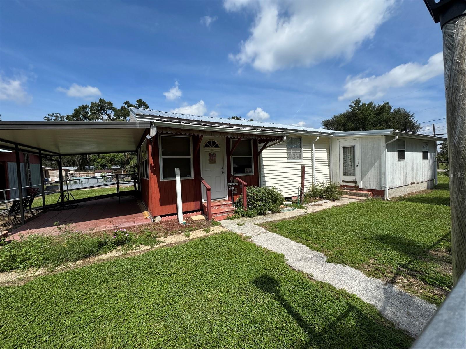 CUTE HOUSE ON .34 ACRE, PROPERTY COMPLETELY FENCED WITH ELECTRIC GATE. KITCHEN & DININGROOM HAVE TILE FLOORING WITH SOLID WOOD CEILINGS, BREAKFAST BAR IN KITCHEN. BATHROOM HAS TILED WALK IN SHOWER. 12x18 FAMILYROOM, COVERED BACK PORCH, METAL ROOF NEW IN 2020, A/C NEW IN 2020, ELECTRICAL UPDATED IN 2020. 2 CAR DETACHED CARPORT WITH METAL ROOF, EXTRA STORAGE WITH CLOSED IN ROOM WITH A/C. MINUTES FROM I-4, SHOPPING & ENTERTAINMENT