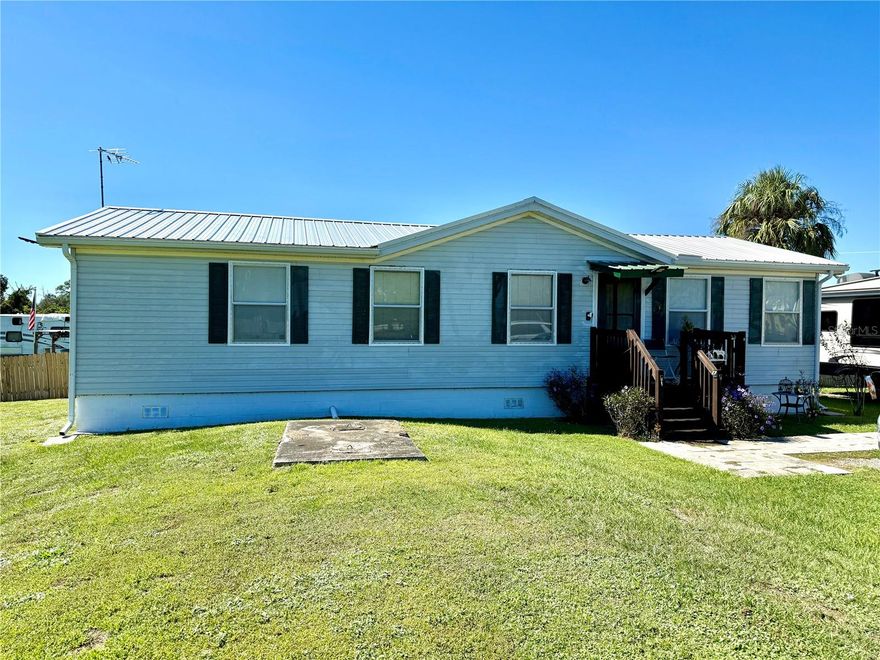 Escape to peaceful country living with this beautifully maintained 3-bedroom, 2-bath modular home situated on 5 serene acres. Offering 1,108 sq. ft. under air (1,324 total), this 1994 home has been thoughtfully updated for comfort, style, and peace of mind. Recent improvements include a new metal roof (2023), new water system and pump (2023), updated water heater, and new laminate flooring throughout the main living areas. The spacious master suite features a walk-in closet and a private bath. A welcoming covered back porch offers the perfect spot to relax and watch the sun set over your private slice of Florida countryside. Enjoy outdoor living with a beautiful above-ground pool, wooden privacy fence, and a large storage shed for all your tools and equipment. End each day watching some of the most breathtaking Florida sunsets right from your backyard. Whether you’re looking for a peaceful retreat, a starter home, or a place to grow, this property offers the perfect blend of country charm and modern updates.