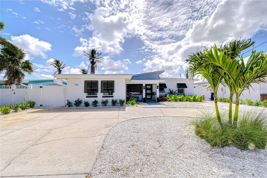 Unrivaled waterfront living takes center stage in this just-renovated coastal masterpiece, perfectly positioned on a deep-water canal in prestigious Bay Point Estates—with quick, direct access to the Intracoastal Waterway and the Gulf of Mexico, placing world-class boating at your doorstep. Your private dock, sparkling pool, and seamless access to John’s Pass further elevate the experience, redefining the boating lifestyle. Enjoy a 1-mile walk to John’s Pass and a 5-minute walk to Madeira Beach and Caddy’s Waterfront Restaurant. A sweeping circular driveway framed by lush landscaping and swaying palm trees creates a striking first impression, offering exceptional curb appeal and ample parking. Inside, this beautifully designed 2-bedroom, 2-bath residence offers 1,802 square feet of light-filled living space, with a welcoming entry and a stylish front office or bonus room framed by glass-paneled doors—perfect for working from home or a quiet retreat. The home opens into a stunning open-concept living area where the kitchen, dining, and living spaces flow seamlessly together, enhanced by natural light and tranquil waterfront views. NEW Roof and A/C in 2025!
At the heart of the home, the designer kitchen showcases quartz countertops, custom bright cabinetry, a center island with seating, and sleek glass-front appliances—ideal for everyday living and entertaining. Warm wood accents, curated coastal lighting, and refined finishes add depth and character, while expansive windows and sliding glass doors create a seamless connection to the waterfront. The open great room is a true showpiece, anchored by a dramatic floor-to-ceiling marble feature wall with a sleek linear fireplace, creating a focal point. Soft coastal tones and generous seating invite relaxation, while walls of glass frame serene water views and fill the space with natural light. The adjoining dining area is perfectly positioned to capture the view, completing the home’s indoor-outdoor flow.
Privately tucked away, the primary suite offers a serene retreat with a light, airy ambiance and thoughtfully designed layout. The spa-inspired ensuite bath features a glass-enclosed shower with elegant tilework, dual vanities, and refined finishes reminiscent of a boutique hotel. A custom walk-in closet completes the suite, offering both style and organization.
Step outside to your private waterfront oasis, where beautifully designed outdoor living spaces invite relaxation and entertaining. A sparkling pool is surrounded by expansive paver decking, offering multiple areas to lounge, dine, and enjoy the coastal breeze. A covered gazebo creates the perfect shaded retreat for morning coffee or evening cocktails, set against wide water views and swaying palms. The lush lawn and thoughtfully landscaped grounds add privacy and charm, enhancing the home’s resort-style ambiance.
Enjoy peaceful moments poolside as dolphins glide by, or unwind on your private dock before heading out for a day on the water—made effortless with your remote-controlled 10,000 lb lift. The dock is new and features lighting for nighttime, two new boat motor lifts, and a fish cleaning station with plumbing and electric. With deep-water access and quick navigation to the Intracoastal Waterway and Gulf of Mexico, this property is truly a boater’s dream.
This is coastal living at its finest—where every day feels like a vacation and the water is always within reach. Schedule your private appointment today!