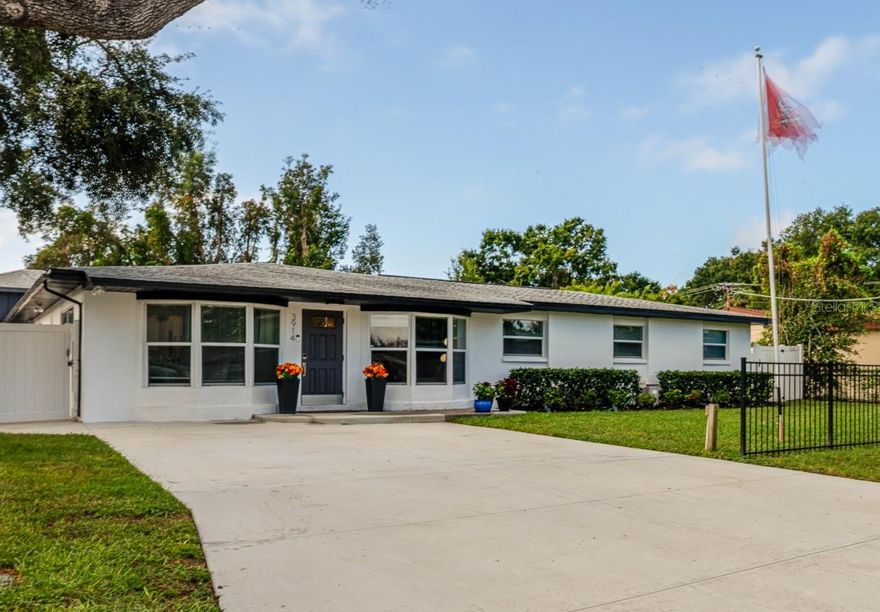 Welcome to your South Tampa dream home — a stunningly renovated 5-bedroom, 3-bath residence featuring a perfect blend of modern luxury and timeless design. From the moment you arrive, the newly paved driveway, lush landscaping, saltwater pool, and privacy fence set the tone for the entertainers dream. Step inside to a bright, open floor plan with abundant natural light and upgrades galore. The living room showcases a striking feature wall with an electric fireplace and integrated surround sound system, creating an inviting space for entertaining. The chef’s kitchen features shaker cabinetry, soft-close drawers, plenty of counterspace with granite counters, a pantry closet, and stainless steel appliances—all designed for both beauty and function. Built-in bar in the living space makes this space ideal for hosting. Each of the five bedrooms includes custom closets, while the primary suite stands out with its own feature wall and electric fireplace. All three bathrooms have been fully updated with modern tile, lighting, and fixtures. Step outside to your private retreat—an expansive backyard with a new saltwater pool, professional landscaping, and entertainment area complete with outdoor surround sound. Perfect for relaxing, entertaining, or family gatherings. Additional highlights include a new roof in 2022, updated floors, fixtures and paint throughout, updated HVAC and windows, water softener, and a one car garage and carport. Situated in a prime South Tampa location just minutes from Ballast Point Park, Bobby Hicks Park, Britton Plaza, Target, and with quick access to the Selmon Expressway, Downtown Tampa, and St. Pete beaches.