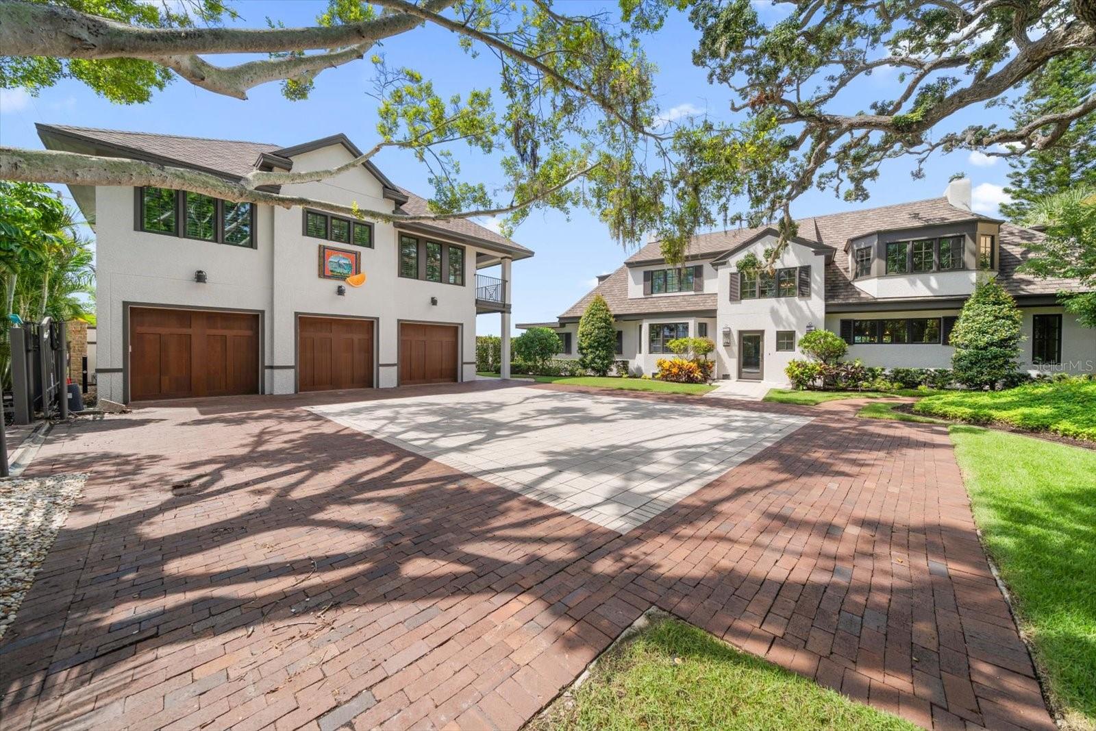 Welcome to Heron House, a century-old 4BR/3BA, 3,604 Sq. Ft. masterpiece with a newly constructed 2 BR/1BA, 1,135 Sq. Ft. carriage house, nestled in the heart of sought-after Dunedin, where history and modern luxury converge. Meticulously renovated to preserve its timeless charm in 2015, this historic home offers unmatched tranquil water views across St. Joseph’s Sound, stretching westward toward the untouched beauty of Caladesi Island, a gem on the Gulf Coast accessible only by boat. With 100 feet of pristine water frontage, the vistas remain as serene as they were 100 years ago when the home served as a luxurious winter retreat for its northern owners. Inside, the versatile floor plan unfolds with a white dine-in kitchen featuring custom shaker-style cabinetry with matching refrigerator and freezer, Cambria countertops and top-of-the-line stainless steel Wolf appliances with natural gas. The spacious family room, bathed in natural light, boasts a cozy fireplace and French doors that open to an expansive screened porch, pool and heated spa, as well as a natural gas firepit—perfect for year-round enjoyment and endless sunset views. Upstairs, period moldings and heart pine floors lead to the primary suite, where French doors open to a sprawling 1,100 sq. ft. balcony overlooking the tranquil park-like setting. The main suite includes a cozy fireplace, a spacious ensuite bath with a double sink vanity, a walk-in shower, a convenient washer/dryer, and a generous walk-in closet with custom built-ins. Additional bedrooms and bathrooms are equally well-appointed and beautifully renovated. Beyond the main house, a recently constructed carriage house adds to the property’s allure, offering a three-car garage (plenty of room for your golf cart) and an elevator leading to a second-floor water-view apartment, engineered to the most stringent waterfront building codes, yet to a design that harmonizes with the older main home. The property is a haven for boating and fishing enthusiasts, featuring a TREX dock complete with two jet-ski lifts and a 9,000-pound boat lift, providing direct access to the Intracoastal Waterway and the Gulf of Mexico.Ideally located across the street from the Pinellas Trail and just north of waterfront Weaver Park, Heron House is a short golf cart ride from downtown Dunedin, where local breweries, charming restaurants, and hand-painted storefronts await. As Southern Living magazine noted in 2023, Dunedin remains delightfully “uncharted,” where first-name greetings are the norm, and a sense of history is woven into the fabric of everyday life. With proximity to Tampa International and St. Petersburg Airports, Heron House is not just a home but a gateway to creating your own cherished memories in a town that celebrates the past while embracing the future.