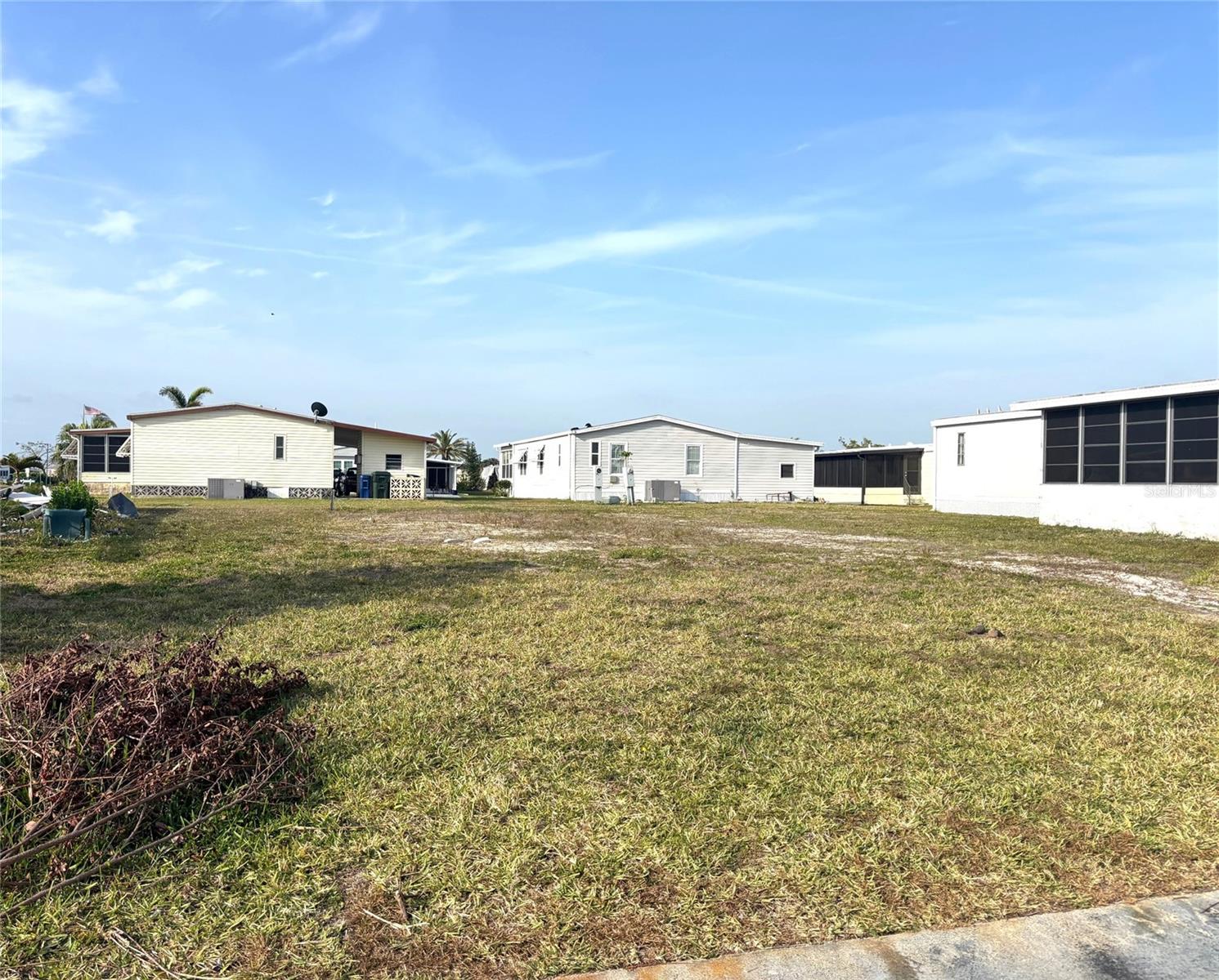 Vacant lot in a vibrant 55+ community! La Casa offers the ultimate Florida lifestyle. We have 974 homes nestled among a variety of native trees with spacious common grounds surrounding our eight lakes. Located between Sarasota and Fort Myers, this is a boater's dream with access to the Gulf of Mexico. It is convenient for shopping, sightseeing, golfing, fishing, and boating, as well as all the culture and elegance the Southwest Florida area is noted for. La Casa may have the best pools in the area. Our crown jewel is an extremely large, 40 X 60-foot swimming pool that is kept at a perfect 87 degrees. Our smaller 20 x 40 pool is quietly nestled between the clubhouse and the Activity Building. Both pools have adjacent hot tubs which are ideal for soaking muscles that are tired from golfing or tennis. Wireless Internet (Wi-Fi) is available at the Clubhouse, Activity Building, and Recreation Hall area where these pools & spas are located, so you can catch some rays while you catch up on your email! Sound enticing? Come for a visit to this self-contained oasis and see for yourself why La Casa is the ultimate destination for both snowbirds and year-round residents!
Welcome to La Casa, an enchanting community where 974 exquisite homes are beautifully set among native trees, surrounded by spacious common areas and eight serene lakes. Our generous 60 by 80-foot lots offer your ideal space. Perfectly located between Sarasota and Fort Myers, La Casa is a boater's paradise with direct access to the stunning Gulf of Mexico. Enjoy easy access to shopping, sightseeing, golfing, and fishing, all while immersing yourself in the rich culture of Southwest Florida. Experience the warmth of Southwest Florida’s winters in a relaxed environment, far from the east coast hustle. Our lush, mature landscaping reflects the dedicated care of residents and management. La Casa features some of the finest pools in the area, including our magnificent 40 by 60-foot swimming pool, maintained at a delightful 87 degrees, and a cozy 20 by 40-foot pool nestled between the clubhouse and Activity Building, both with inviting hot tubs. Stay connected with our complimentary Wi-Fi at the Clubhouse, Activity Building, and Recreation Hall while you soak up the sun. La Casa is a family-friendly haven where you can enjoy tranquility while remaining close to vibrant attractions. Come visit our charming oasis and discover why La Casa is the ultimate destination for snowbirds and year-round residents!