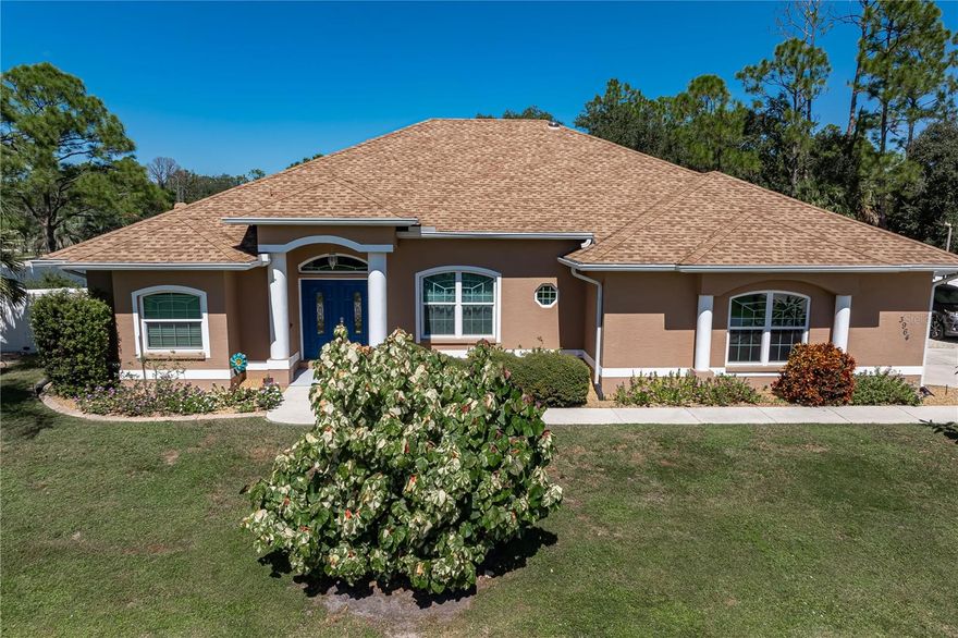 UPDATED NORTH PORT HOME WITH POOL ON DOUBLE LOT - Beautifully-maintained 3 bed/2 bath North Port home with a saltwater pool boasts over 2,200 square feet of living space and sits on a spacious double lot with a fully fenced yard, lush tropical landscaping, and mature fruit trees. Located in a quiet neighborhood on a corner lot, the home blends privacy, comfort, and modern updates while being just minutes from shopping, dining, and everyday conveniences. Inside, the open-concept layout features high ceilings, crown molding, elegant columns, and tile flooring throughout. Disappearing sliding glass doors create a seamless flow between indoor and outdoor living spaces. A sitting room off the main living area offers flexible use as a breakfast nook, home office, or cozy den, while the spacious formal dining room is ideal for gatherings. The kitchen is designed with both function and style in mind, featuring solid surface countertops, stainless steel appliances, and a breakfast bar that opens to the great room. The dedicated RO (reverse osmosis) system for the refrigerator has a discrete drain line. The master suite is a true owner's retreat with a spa-like en-suite bath that includes a freestanding soaking tub, a large frameless glass shower, split vanities with quartz counters, and upscale finishes throughout. The split-bedroom design provides added privacy for owners and guests alike. One guest room has a wall of built-in bookshelves - creating an ideal home office or flex space. The guest bedrooms share a guest bath that doubles as a pool bath with access to the lanai. Outside, the screened lanai offers a covered seating area and a large pool deck surrounding the in-ground, saltwater pool. Lush, tropical landscaping surrounds the pool cage creating the feel of a private oasis in your backyard. Garden/flower beds have in-ground irrigation system. New 10x16 shed w/ramp in the backyard is perfect for housing your gardening equipment or any other tools or toys. The oversized 2-car garage includes additional space for storage, and the extended driveway with a bonus carport offers ample parking options. With a new shingle roof in 2023, an HVAC system updated in 2025, impact windows throughout, and tile floors in every room, this home is truly move-in ready. It offers a rare combination of space, upgrades, and privacy on a quiet street in North Port—with no HOA and all the benefits of Florida living at your fingertips. Make an appointment today.