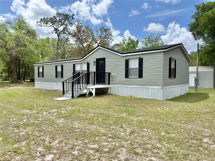 REMODELED CORNER LOT 3/2 Double-Wide Manufactured Home sitting on 1.25 ACRES located in one of the most desirable areas in Dunnellon, FL!! This freshly painted MOVE-IN ready home has a BRAND NEW ROOF & BRAND NEW AC UNIT along with BRAND NEW DUCT WORK throughout the home. This home also features 1,344 SqFt of living space, a FIREPLACE, BRAND NEW White kitchen cabinets with Quartz countertops along with BRAND NEW Samsung kitchen appliances, BRAND NEW Luxury Vinyl Plank flooring throughout the home with PORCELAIN TILE in the master suite bathroom & guest bathroom, BRAND NEW vanities with Quartz countertops, BRAND NEW light fixtures, window blinds and baseboards. The spacious Master Suite includes a big walk-in closet along with HIS & HERS vanity sinks, new toilets and a luxurious BRAND NEW TILED shower stall with a BRAND NEW glass door. The home has a septic system that has been serviced and drained. The well system has also been serviced. The exterior of the home features a HUGE fenced-in 1.25 Acre Lot, BRAND NEW front & rear porch and a BIG metal shed that is perfect for storage. Zoned A-1, and also NOT IN A FLOOD ZONE! Bring your farm animals! This home WILL NOT last long on the market, hurry submit your offer before it’s gone!