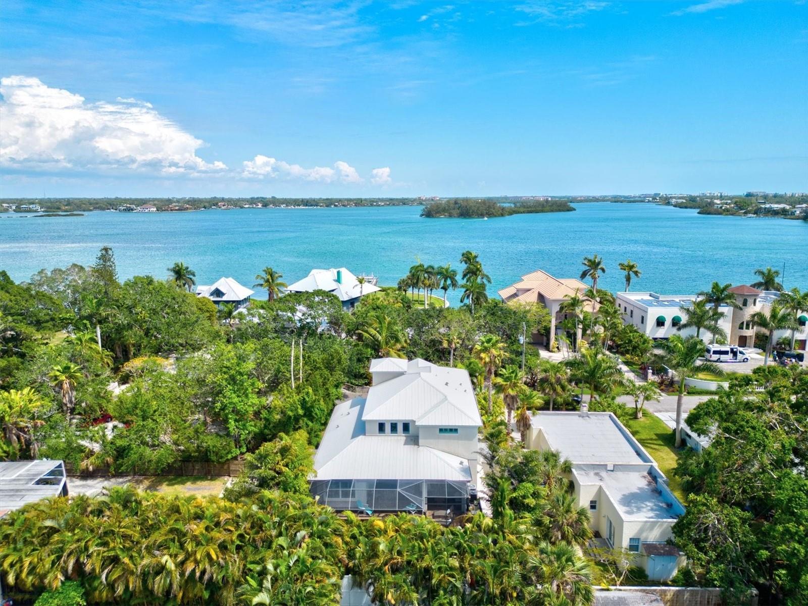 **PRICE REDUCTION, MAKE YOUR OFFER** Welcome to your dream home on Roberts Point, where coastal living meets luxury. This beautifully designed “Kristi” Model by award-winning luxury custom builder, Allegra Homes, located on the north end of Siesta Key and nestled within the coveted enclave of Roberts Point. Highly sought after location on the North end of Siesta Key within minutes of Shell Beach, Siesta Beach, dining, and shopping. This home is ONE of only around 70 homes on this very private and exclusive enclave. This stunning property boasts views of the sparkling turquoise waters and dazzling sunsets that only the coastal areas of Sarasota can offer. As you step into the foyer, you'll be greeted by an open floor plan that seamlessly blends indoor and outdoor living. The expansive living room offers breathtaking vistas and plenty of natural light, creating an airy and inviting ambiance. The gourmet kitchen, equipped with top-of-the-line appliances and sleek countertops, is a chef's delight and perfect for entertaining. The private Owners Suite, on the first floor, has a private exit to the pool and lanai and boasts two walk-in closets, an ample sized bathroom with dual sinks and a large walk-in shower. Up the stairs on the second level you have a private guest suite equipped with it's own private bathroom. Beyond the guest suite, up a few more stairs, you have the upper level which boasts two more guest bedrooms which share a bathroom and a large bonus/flex space. This flex space could have a wide range of uses such as a theatre room, home gym, or play area for the young ones. The outdoor space is an entertainer's dream, featuring a heated pool and spa, summer kitchen, and plenty of seating areas. You'll love hosting barbecues and gatherings while taking in the coastal lifestyle that is unique to this highly coveted neighborhood. There is lots of room for accessories in the oversized, 2 car garage with large, enclosed storage locker. A low maintenance fenced back yard, and landscaping and security cameras, makes this a perfect home for part or full time living. Located in one of the most coveted neighborhoods on Roberts Point, this home is just minutes away from Siesta Key Beach, renowned for its powdery sand and clear waters, as well as fabulous dining and shopping. This is your chance to live the ultimate coastal lifestyle in one of the most sought-after communities on the Gulf Coast.