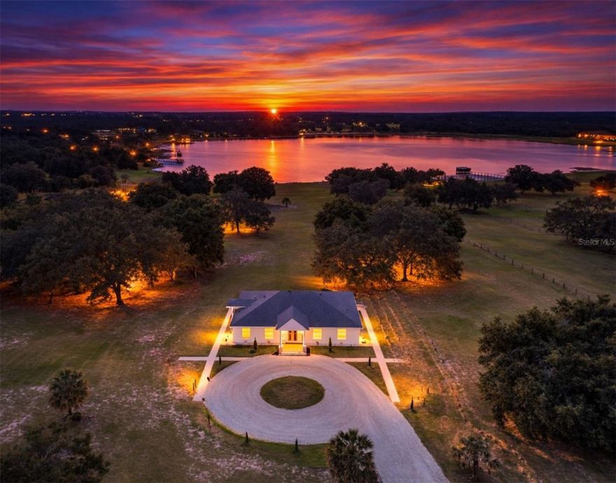 Discover the ultimate retreat at 11155 Cherry Lake Road, where luxury meets the serene beauty of Lake Apshawa. This stunning estate offers over 2,700 square feet of modern living space set on more than six sprawling acres of private lakefront property. With four spacious bedrooms plus a flex space for a office/den/5th bedroom and three full bathrooms, the home features an inviting open-concept layout designed to maximize natural light and capture breathtaking waterfront views from nearly every room. High ceilings and premium tile flooring lead you through a chef-inspired kitchen that flows seamlessly into the family and dining areas, creating a perfect environment for both quiet evenings and lively gatherings.The expansive outdoor space is a rare find, providing complete freedom with no HOA restrictions. Whether you envision an equestrian haven, a private dock for kayaking, or a custom-gated masterpiece, this property offers endless possibilities. One of the home's most remarkable features is the perfect balance of seclusion and accessibility. You can enjoy the absolute peace and quiet of your own private acreage, yet you remain just minutes away from the vibrant heart of Clermont. This location offers the rare convenience of being close to local dining, shopping, and major highways, all while feeling like a remote sanctuary. Situated high above sea level, you can enjoy panoramic vistas of rolling hills and nightly views of world-famous theme park fireworks and the space coast rocket launches. This is a truly unique opportunity to own a piece of paradise that offers the best of both worlds—unmatched privacy and everyday convenience. Schedule your private tour today to witness this exceptional lifestyle for yourself.