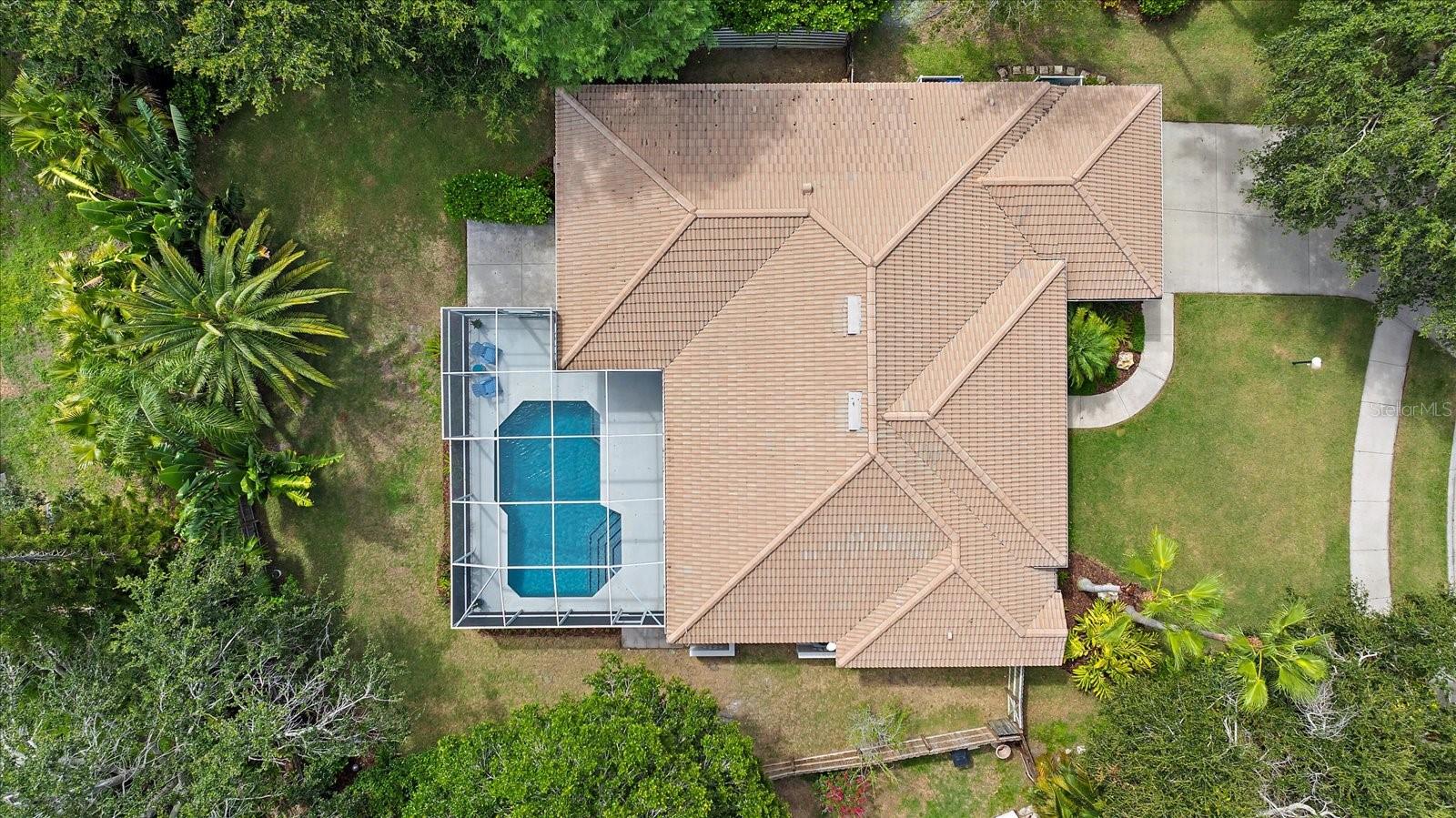Tucked within the highly desirable Three Oaks neighborhood of Sarasota, 5619 Oak Grove Court is nestled in a serene enclave known for its namesake tradition: each home was originally required to be accompanied by the planting of three oak trees, creating a lush, shaded community rich in character and charm. Positioned on a spacious, nearly 12,000-square-foot lot at the end of a quiet cul-de-sac, this 4-bedroom, 2-bath, 2,422-square-foot residence offers both tranquility and functionality—ideal for growing families, seasonal residents, or anyone in search of a true Florida pool home with room to breathe.
Enjoy peaceful mornings in your northeast-facing backyard, where filtered sunrises peek through majestic mature oaks and reflect on the sparkling, oversized pool. The fully fenced yard provides privacy and security for children or pets, while the generous covered lanai sets the stage for effortless outdoor living—from poolside lounging to casual dinners under the stars. Evening strolls through this quiet, low-traffic neighborhood are complemented by glowing sunsets from your front door, all within the safety and value of Zone X—no flood insurance required, and no history of storm damage. This home is also free of CDD fees, offering added savings and peace of mind.
Built with durable concrete block masonry and cement-based stucco, the home has been well maintained and thoughtfully updated over the years. Inside, a bright and open layout connects the formal living and dining spaces with a central kitchen and a comfortable family room. The kitchen offers a closet pantry, reverse osmosis for the sink, fridge and ice maker, ample counter space, and a clear view of the pool, allowing for seamless indoor-outdoor living. Sliding glass doors from the primary suite, formal living room, and family room invite natural light throughout and strengthen the connection to the beautiful backyard oasis. The split-bedroom layout features four bedrooms and two full baths, with the fourth bedroom currently serving as a home office or den. With its own closet, it can easily convert into a private guest suite or creative flex space.
Notable improvements include a new HVAC system installed in 2023, saltwater pool conversion and resurfacing completed in 2019, and hurricane shutters added in 2021. The roof, a hip-style barrel tile, dates to 1999 but benefits from a tax-effective year of 2004. Additional updates include a new electrical panel in 2019, a water heater from 2016, new washer and dryer in 2019, and updated flooring in three bedrooms and the office/den. The home was freshly painted, power-washed, and professionally landscaped in 2025, further enhancing its curb appeal. Practical touches like the raised AC handler in the garage ceiling for quieter operation and more interior space, pull-down attic storage, and a built-in workstation in the oversized garage make this home as functional as it is beautiful.
Located within an A+ rated Sarasota school district and just minutes from I-75, The Legacy Trail, premier shopping, and the world-renowned beaches of Siesta Key, 5619 Oak Grove Court presents the perfect balance of lifestyle, location, and long-term livability. Whether you're snowbirding, raising a family, or simply looking for a peaceful place to call home, this thoughtfully designed and impeccably maintained property checks every box.