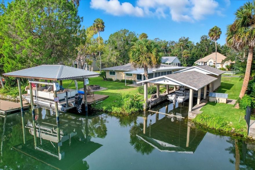 One or more photo(s) has been virtually staged. Waterfront Living, Incredible Location in the Heart of Homosassa! This spacious 3-bedroom, 2.5-bath, 2-car garage ranch-style block home offers 2,200 sq. ft. of living space on a .3-acre corner lot and is just a short swim or paddle to the pristine waters of the world-famous Homosassa Springs. Here, you’ll be surrounded by manatees, dolphins, and an abundance of natural wildlife. Boaters will love the setup: a 2,000-lb lift boathouse PLUS a separate 10,000-lb covered boat lift with its own deck, floating dock, and kayak launch. With 105 feet of waterfront frontage, there’s room for every water toy. Originally built in 1972 the home sits proudly on a highly desirable Old Florida street with NO HOA or Deed Restrictions. The newly remediated home now features all new green board, a modern kitchen, new doors, new water heater, and garage door—all meticulously self-renovated with care and attention. Major systems include a 2019 AC, 2023 roof, and an advanced aerobatic septic system. The home offers 2 ensuite baths both with walk-in showers and modern finishes, an enclosed covered patio with abundant windows that overlook the deepwater canal, the detached garage is the perfect workshop or storage spot, and the spacious corner lot location with room to park your boats and trailers all add to the appeal, creating a home that is as functional as it is full of character. Whether you’re looking for a weekend escape, a full-time residence, or an investment in one of Citrus County’s most iconic waterfront communities, this property combines location, lifestyle, and long-term value.