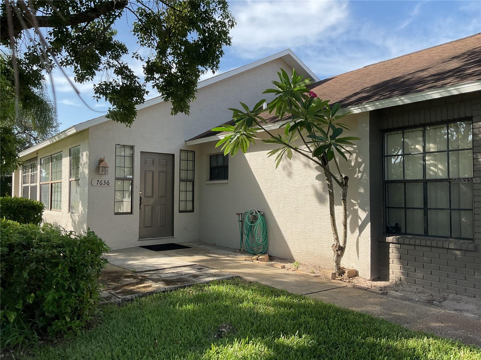 One or more photo(s) has been virtually staged. Welcome to 7636 Haig Court, a spacious villa tucked away on a quiet cul-de-sac in Ruxton II, part of the Tall Pines at River Ridge community in New Port Richey. Priced at $237,000, this 2-bedroom, 2-bathroom end-unit offers over 1,300 square feet of potential-filled living space, ideal for buyers looking to personalize a home in a well-maintained neighborhood.
This residence features vaulted ceilings and an open living and dining area that provides a great foundation for entertaining or everyday living. This home is clean and functional, and is priced to allow you an outstanding opportunity to customize your next home to fit your style.
The primary suite includes an ensuite bath with step-in shower. The second bedroom is ideal for guests with a nearby full bath for added convenience. A laundry closet is located inside, and the attached one-car garage offers additional storage. Off the rear of the home, a screened-in lanai overlooks green space—perfect for morning coffee or evening relaxation.
Ruxton II is a deed-restricted sub-community within Tall Pines, a master-planned development of five distinct villages. Homeowners enjoy community-maintained landscaping, exterior maintenance, trash and recycling, and access to walking areas and shared amenities.
Conveniently located near Ridge Road and Little Road, this home is close to everything. Grocery stores, pharmacies, medical offices, and restaurants are just minutes away. The Suncoast Parkway is nearby, providing direct access to Tampa International Airport in approximately 45 minutes and to St. Pete–Clearwater International Airport in about 50 minutes.
For recreation and nature lovers, Sims Park, Jay B. Starkey Wilderness Park, and the scenic Cotee River are just a short drive. Gulf beaches including Howard Park, Honeymoon Island, and Clearwater Beach are close by.
Zoned for Cypress Elementary, River Ridge Middle, and River Ridge High School, this home is a fit for a variety of buyers—from first-time homeowners to those looking to downsize.
Schedule your private showing today and explore the opportunity to make this home your own.