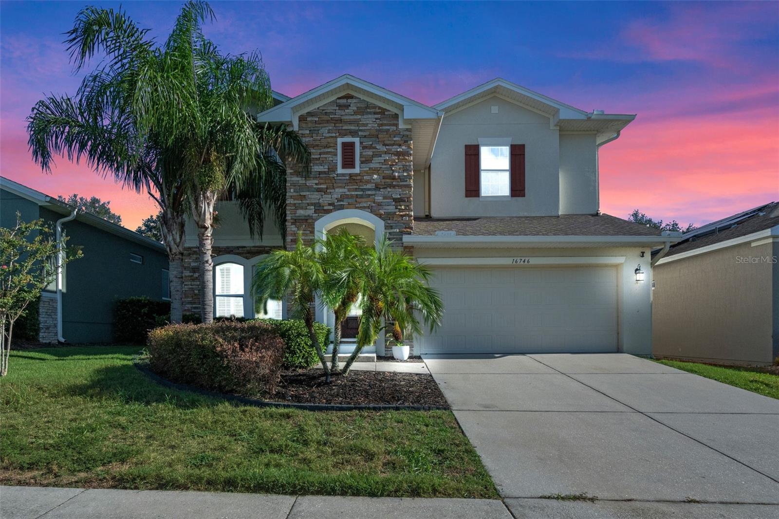 This exceptional residence, crafted by renowned builder David Weekley, offers 4 spacious bedrooms, 3 full bathrooms, 1 half bath, and more than 3,000 square feet of beautifully appointed living space. Thoughtfully upgraded throughout, this home blends timeless design with modern luxury. From the moment you step through the front door, soaring ceilings, abundant natural light, and gleaming hardwood floors set the tone. At the front of the home, a dedicated office features custom built-ins, designer lighting, and tailored shelving, while the elegant formal dining room provides the perfect setting for entertaining. The heart of the home embraces an open-concept design, seamlessly connecting the living room, chef’s kitchen, and casual dining area. The living room exudes warmth and grandeur with exposed wood beams, a striking stone fireplace with integrated TV mount, and expansive windows framing lush, mature landscaping. The kitchen offers generous cabinetry, a large center island, premium stainless steel appliances, and rich granite countertops. The main-level owner’s suite is a private retreat, featuring hardwood floors, a second stone fireplace, wood-beamed ceilings, and a spa-like ensuite with dual vanities, a walk-in shower, and an oversized walk-in closet. Upstairs, a sprawling bonus room offers endless possibilities—perfect for a media room, game space, or secondary living area. Three additional bedrooms with large closets and two full bathrooms provide comfort and privacy for family or guests. Designed for both relaxation and entertaining, the backyard features an expansive screened lanai and a custom putting green, creating a resort-like atmosphere. The garage is currently transformed into a fully equipped golf simulator room—ideal for golf enthusiasts—though it can easily be converted back to a functional garage if desired. This John’s Lake Landing gem combines luxury, comfort, and unique amenities, making it a truly one-of-a-kind offering. You're also nestled within a well-established community, this property enjoys an enviable location close to major highways, ensuring convenient access to all amenities. Just minutes away, residents can indulge in excellent shopping opportunities, dine at a variety of luxury and casual eateries, and explore nearby theme parks for entertainment. The neighborhood benefits from proximity to brand-new, state-of-the-art hospitals and a top notch school system, providing peace of mind for residents seeking quality healthcare services and high end education for their family. This vibrant community offers an abundance of options to suit every lifestyle need and preference. Call today to schedule a private tour.