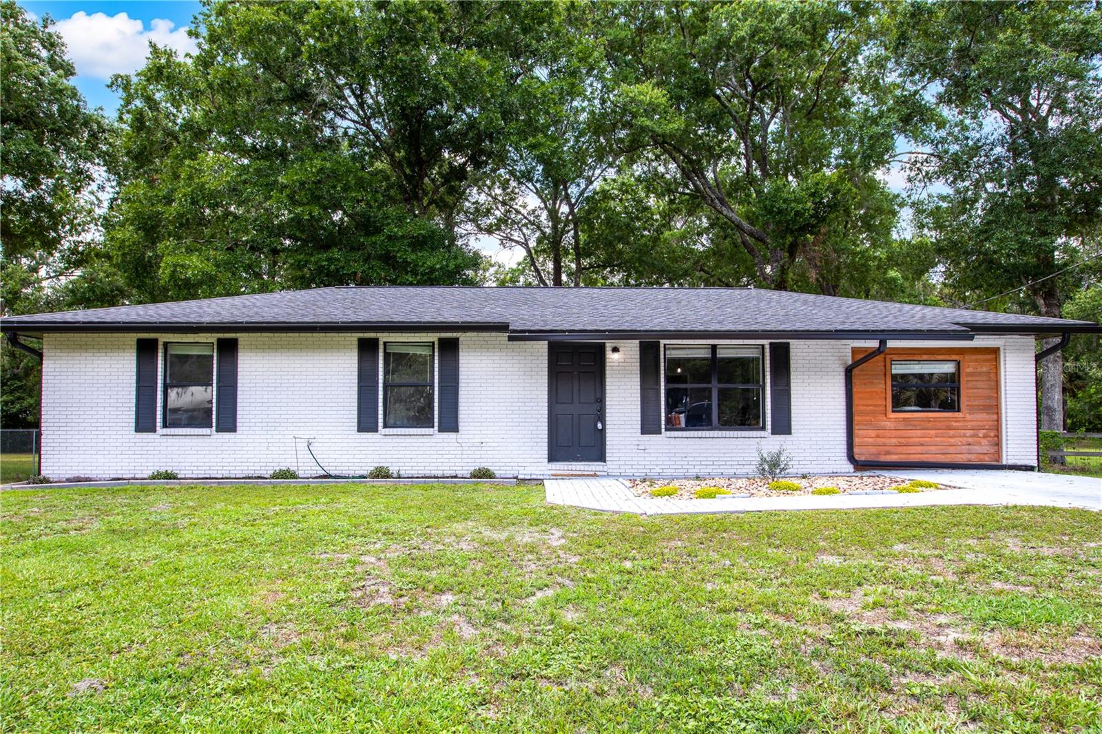 Nestled on nearly a 1/2acre in one of the most desirable areas of Starke, this fully renovated 3/2+Bonus room is everything you’ve been searching for! Upon arrival, a stone driveway leads you to a brick home with custom cedar accents, aesthetic landscape, recently installed gutters, and a newer roof (2018). Inside, you’ll find an open concept design deserving of awe, as nothing was left undone to create the perfect blend of luxury, quality, and convenience. The chef-inspired kitchen boasts elegant wall-to-wall backsplash, quartz countertops, soft close cabinetry, stainless appliances and an industrial range hood, and a perfectly situated window allowing direct backyard views. The fabulously renovated bathrooms include a custom-designed tiled walk in shower and timeless selections from top to bottom in the primary suite, while the guest bath boasts chic wallpaper, a quartz counter vanity, glamorous fixtures, and a newer tub. Best of all, the bonus room allows an abundance of opportunities - as either another living room, a 4th bedroom, an oversized office, a workout room, or a dream playroom; and laminate and tile throughout provide low maintenance living with no carpet! Stepping outside, enjoy everything you look for in a backyard - with a concrete patio as a perfect spot to throw a bbq, a MASSIVE backyard with over 13,000SqFt for your fur babies to roam, and a deep set lot configuration that truly makes it feel even larger than it is. The prime location is 5 minutes to all shops and restaurants of Starke, 5 minutes to the overpass, 25 minutes to Gainesville, and 35 minutes to Jacksonville. This move-in ready home truly has it all, for the most affordable price on the market. Shed in backyard is negotiable. Call today to schedule your showing!