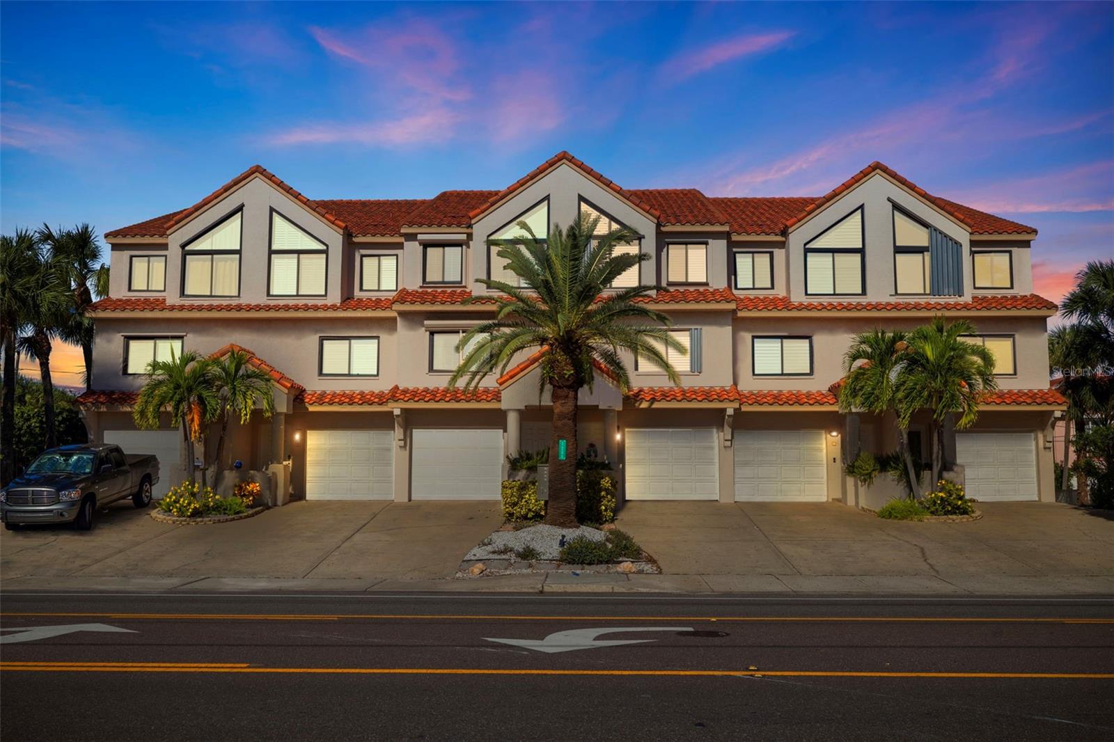 Experience the magic of Indian Rocks Beach in this impeccably updated, pet-friendly townhome just steps from the sand—without the premium price of direct beachfront living. This 3-bedroom, 4-bath residence offers front-row views of the Gulf of Mexico from the comfort of your primary suite, all within a vibrant coastal community known for its laid-back charm and walkable lifestyle. NO FLOODING DURING THE 2024 HURRICANES and no compromises inside—just elevated finishes, thoughtful upgrades, and turn-key convenience. The chef-inspired kitchen is a standout with custom cabinetry, polished stone countertops, and generous prep space that caters to everyday cooking and elegant entertaining alike. The primary suite offers the perfect vantage point to unwind with nightly sunsets, while the spa-style ensuite bath has been fully remodeled with luxurious finishes. Enjoy clean air and cool comfort year-round with a Rheem AC system featuring advanced UV filtration. On the ground level, a private patio courtyard invites alfresco entertaining, while the oversized 2-car tandem garage adds practicality with plenty of room for beach gear, bikes, or a golf cart. Perfectly positioned near 12th Avenue Park and just a few steps from the shoreline, this residence is coastal living at its most effortless. Whether you're looking for a second home, a savvy investment, or a full-time beach retreat, this one checks every box.