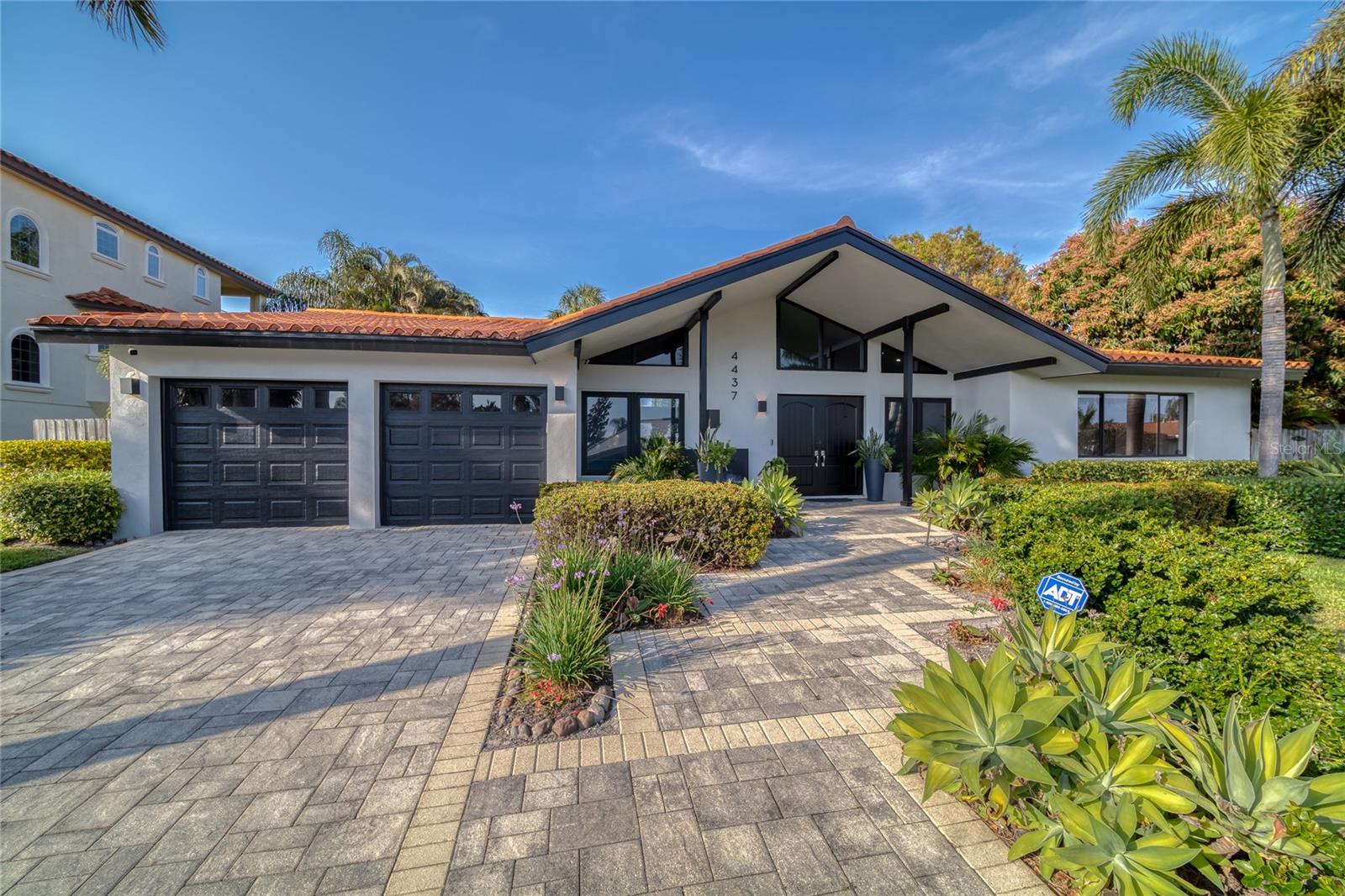 Experience the ultimate Florida lifestyle in this luxurious waterfront bungalow located in beautiful Saint Petersburg. As you enter, you will be greeted by a stunning library complete with beautiful built-ins, perfect for relaxing and unwinding. This home has been thoughtfully updated with new features including a sparkling heated fiberglass pool, deluxe outdoor kitchen, water heater, travertine pavers, tile floor in the guest suite, garage floor, and garage organizer. The great room design allows you to "be" part of everything inside while enjoying the view of the huge backyard oasis. The vaulted ceilings and beautiful picture window fill the home with light and space. It took a decade to create the privacy that you'll find here, and it's well worth it. There are two generous master suites, and the split bedrooms give everyone their own space. The outdoor living space is an entertainer's dream with a lovely paver patio featuring an outdoor kitchen to die for. The heated pool and grassy lawn surrounded by lush tropical landscaping make it the perfect place to entertain family and friends. The private dock with lift is complete with freshwater and electric, a 16,000 lb. boat lift, and a floating dock ideal for launching kayaks or paddleboards. The beautiful glass-enclosed tiled shower and large soaking tub offer a spa-like experience, while the chef's kitchen with luxury stainless steel appliances and gas range make cooking a delight.
Don't miss out on the opportunity to live the Florida dream in this beautiful light and bright home with your outdoor oasis. Schedule an appointment to see this outstanding waterfront bungalow today.