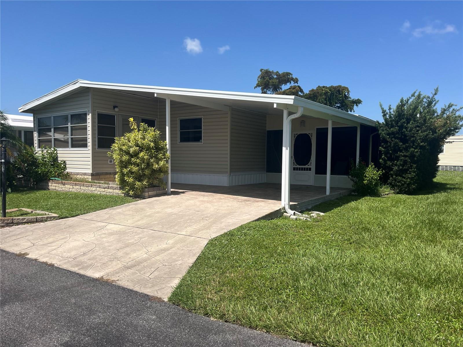 Brand-new roof (home, carport & shed) installed 7/25/25! This 2BR/2BA home features an enclosed front lanai for extra living space, covered carport, and screened patio with workshop/storage area & washer/dryer hookups. Functional floor plan with great potential—interior needs updating, flooring repair in front & dining rooms, and new appliances, but range & fridge work. Carpeting throughout needs replacing. Priced to reflect condition. Westwinds Village, a friendly 55+ community, offers a clubhouse, large pool, on-site management, and numerous amenities for an active lifestyle. Don’t miss this opportunity to create your perfect Florida home!