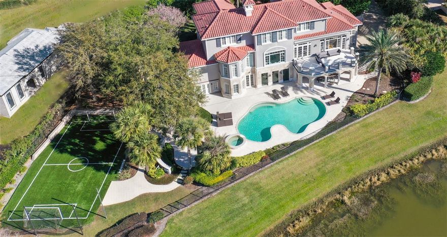 PRICED TO SELL!!!! Your family simply must see this heavenly retreat! Nestled on a tranquil cul-de-sac, this Isleworth estate will steal your heart. From every corner of the house, you'll be captivated by the breathtaking views of Hourglass Pond. As you step into the living room, your eyes will be drawn to the sparkling water and the lush greenery of the golf course. With six spacious bedroom suites and a half bath, this home is designed for both luxury and comfort. It's a haven for entertaining, with outdoor areas that boast an exceptional summer kitchen, an oversized pool, and even a state-of-the-art synthetic soccer field. Imagine the joy of spending your evenings on the spacious upper deck, surrounded by the serenity of the pond, the beauty of the golf course, and the hues of a glorious sunset. And that's not all! The lower-level is a haven of fun, with a billiard room, a cozy kitchenette, a TV room for movie nights, guest quarters, a full pool bath, and a convenient laundry room. This house is a dream come true.