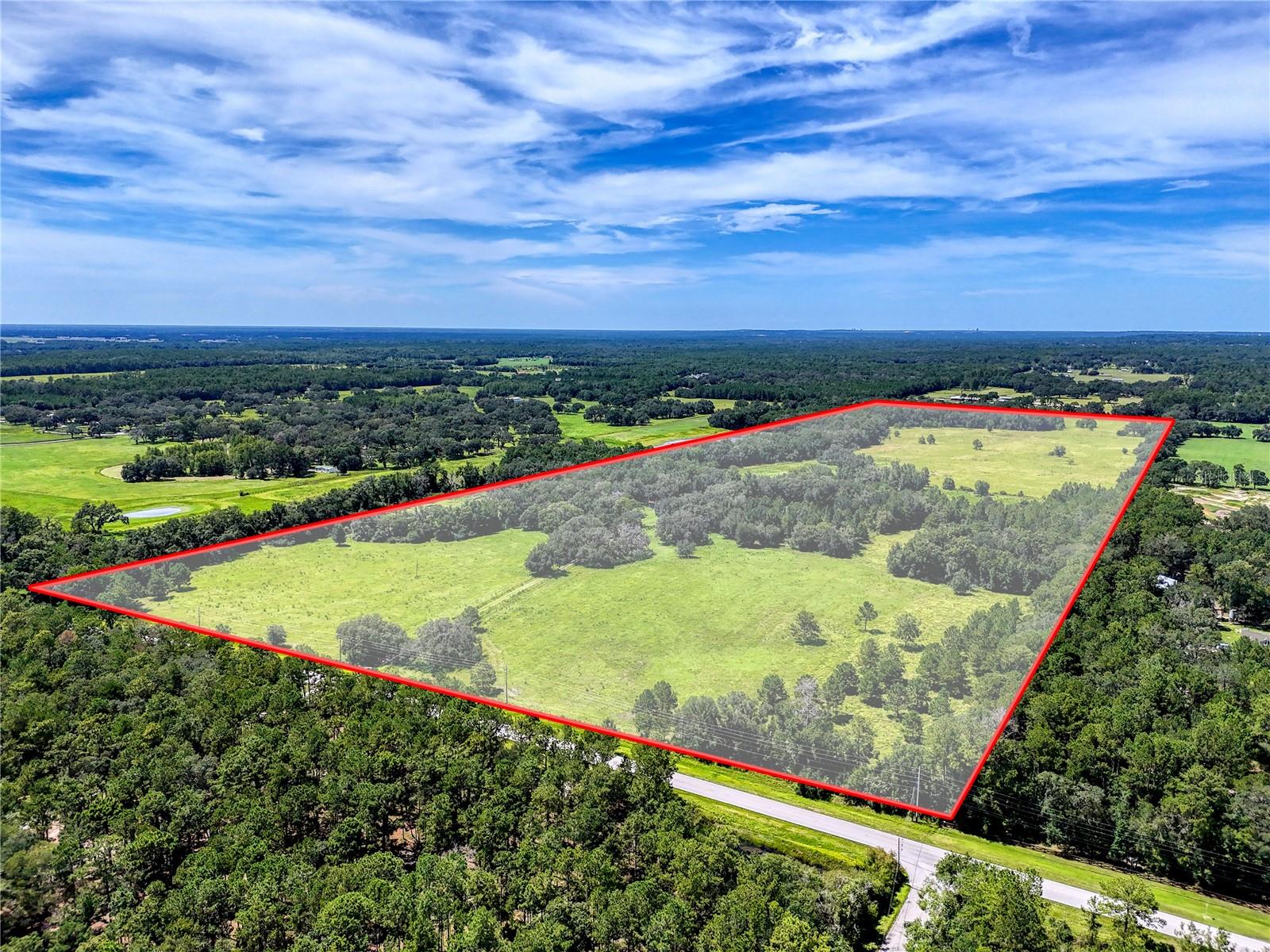 135-Acre Estate in Central Florida - Rolling Hills, Grandfather Oaks & Boundless Potential! Discover a rare opportunity to own 135 stunning acres in the heart of Central Florida. Nestled among gently rolling hills and framed by majestic grandfather oaks, this expansive estate borders scenic Squirrel Prairie Lake and offers the perfect balance of natural beauty, privacy, and versatile use. Whether you're dreaming of building your forever home, developing an equestrian estate, investing in future development projects, or continuing its use as a productive working farm, this property caters to a wide range of visions. Highlights include: Over 100 acres of high, dry, buildable land with panoramic views and multiple homesite options. Rolling pastures, mature oak hammocks, and serene natural water sources. Two existing homesites, each with its own septic system, well, and electrical meter. Established fencing and cross-fencing, ideal for livestock or equestrian use. Zoning suitable for low-density residential or equestrian development. Enjoy the peace and privacy of a rural setting without sacrificing convenience. The property is centrally located with quick access to major highways, making it just under an hour to both Tampa and Orlando. You're also minutes from charming small towns, local markets, and recreational destinations throughout the region. Whether you envision a private retreat beneath the oaks, a boutique residential community, or a continuation of its agricultural legacy, this 135-acre estate is a rare blank canvas ready for your unique vision.