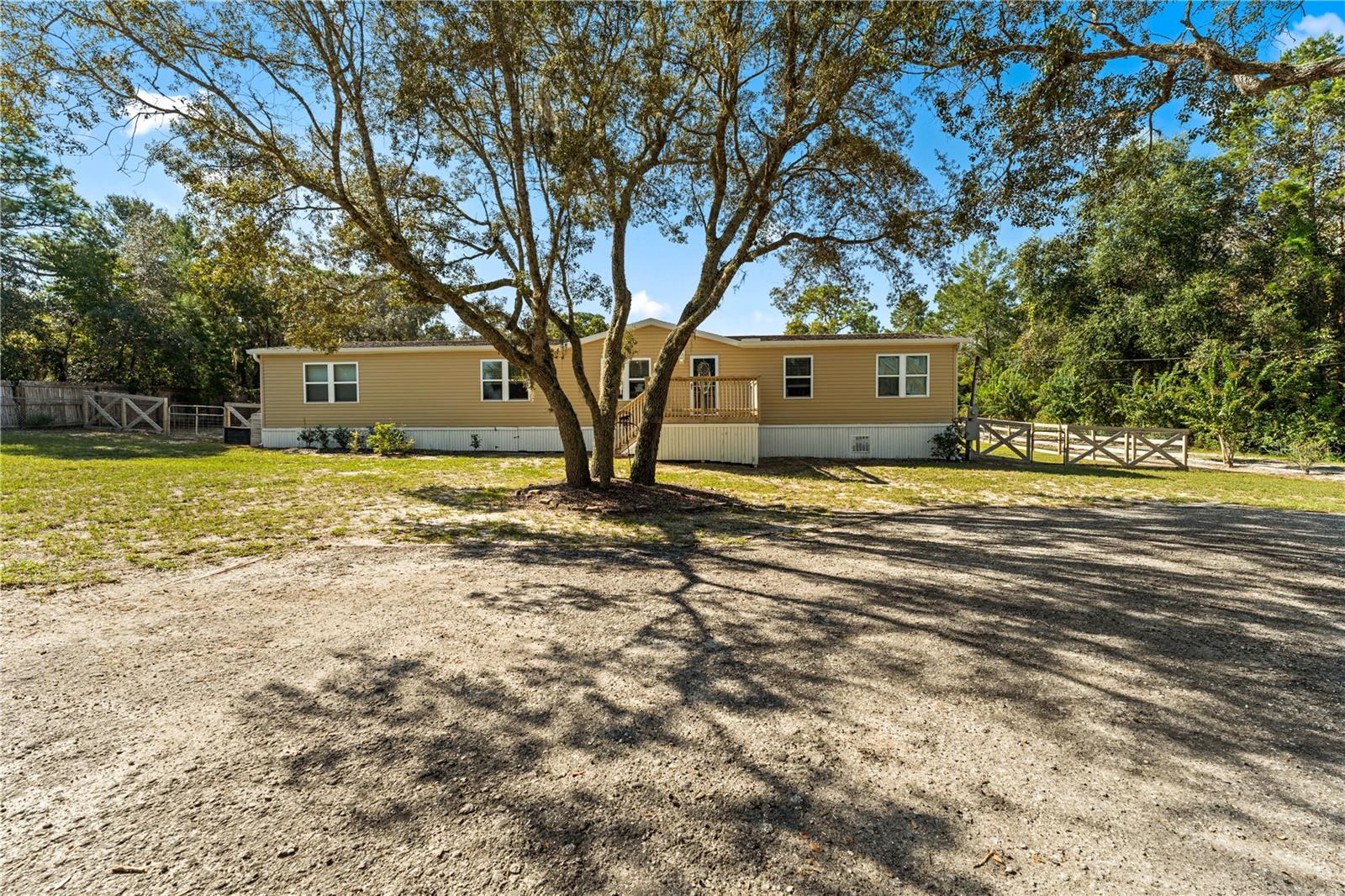 Welcome to this meticulously updated manufactured home, offering a perfect blend of comfort and functionality on a sprawling 2.39-acre lot, ideal for mixed-use with endless possibilities. With four spacious bedrooms and two well-appointed bathrooms, this residence is designed for modern living. The master suite features a walk-in closet and a dual-sink vanity, providing a serene retreat. The oversized living room and dining area are perfect for entertaining, while the updated kitchen, complete with newer appliances, caters to culinary enthusiasts. Fresh paint and updated LVP flooring flow seamlessly throughout the home, enhancing its contemporary appeal.
Outside, the property is a true oasis, with one full acre fully fenced for privacy and security. Bring your horses, goats, and all creatures; there’s plenty of space to accommodate your animals with a four-stall barn and two storage sheds for all your outdoor needs. Enjoy the inviting outdoor spaces, including a 10x10 deck at the front and a large deck surrounding the above-ground pool in the back, perfect for summer gatherings. A convenient circular driveway offers ample parking and easy access. Best of all, there’s no HOA, allowing you the freedom to fully enjoy your property. This exceptional home combines rural charm with modern amenities, making it a must-see for anyone seeking a tranquil lifestyle filled with endless opportunities.