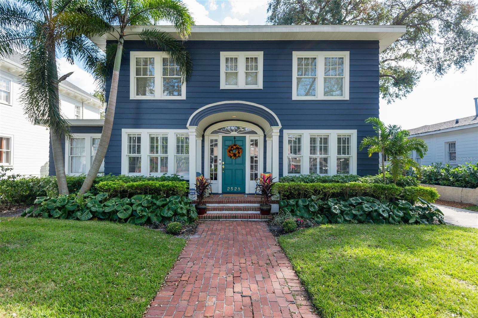 Welcome to this traditional home in the heart of coveted New Suburb Beautiful! This 1927 charming home features a rare 5 bedrooms, 3.5 baths, office, beautiful oak and pine flooring throughout, 3 fireplaces and a welcoming foyer. The entire interior has been freshly painted in neutral tones. The main floor's traditional floor plan includes a newly renovated kitchen, formal dining room featuring the home's original chandelier, designated office or play room with grasscloth wallpaper, a cozy breakfast nook, and a sprawling living room that flows into a sunken family room with wood burning fireplace. The second floor features five generously sized bedrooms, including a light-filled primary suite with fireplace, dual vanity sinks and walk-in closet. The second bedroom boasts a beautifully remodeled ensuite bathroom, while the remaining bedrooms share a chic black-and-white hallway bathroom. Step outside to a true paradise: a spacious screened-in patio and pool oasis complete turfed yard, fenced for privacy. With a custom putting green for golf enthusiasts and ample space to dine al fresco or lounge, this outdoor haven is ideal for both relaxation and hosting. This home is perfect for those who value elegance, comfort, and exceptional spaces for entertaining—indoors and out. Roof 2024, two AC replacements 2021, pool 2021. Additional features: 2 car garage with additional side storage, electric vehicle charging station along driveway, whole house water softener and filter and a reverse osmosis system in the kitchen. Located in A-rated Mitchell/Wilson/Plant school district. Walking distance to Bayshore Blvd, Palma Ceia Park, Bern’s, CAMP, Cru and more local hotspots!