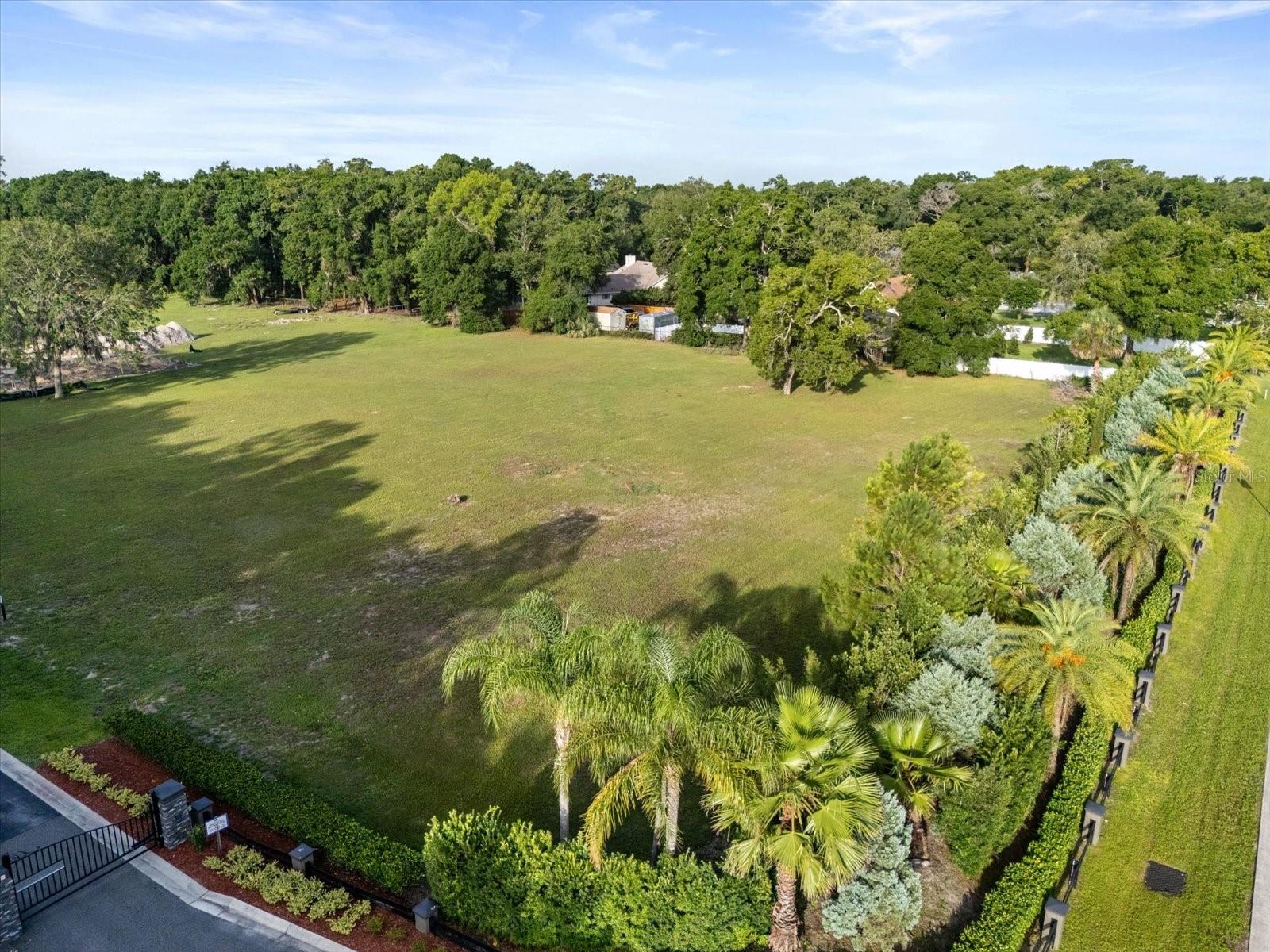 ONE ACRE CUSTOM HOME-SITE Visit Matera today, the first new custom home has begun! Schedule a meeting with the Builder! Gated Luxury living in Seminole County. One of only a few remaining places in Seminole County to build your new CUSTOM HOME. One acre home sites are hard to find. Matera offers one acre home sites, gated with County water and natural gas available to each home. Plus you can build your In Law Suite/ADU up to a max of 1000 SF, with a kitchen for the In Laws or Guests.
Build your dream home in a pristine gated community focused on luxury-living in peace and harmony. This small, private, community in Seminole County now has new owners. New custom homes are built exclusively by award-winning home builder Tolaris Homes. Only (3) one-acre home sites are remaining. Homes start at $1.2 Million with a minimum of 3,400 sq. ft. living required. Respectful and private housing of a boat, RV, and/or bus is permitted.
Matera is in close proximity to numerous hospitals in Lake, Volusia, Seminole and Orange County with easy access to the brand new Orlando Loop (SR 417/529), Disney World as well as THREE airports: Sanford Orlando International (SFB), Orlando International (MCO), and Daytona Beach International Airport (DAB). Matera is also a short drive to Historic Downtown Sanford and DeLand, both of which are filled with dining, shopping, history, lakes, and scenic walks. Excellent schools.Please call for more details.
*Home construction must begin within 6 months of the home site closing.