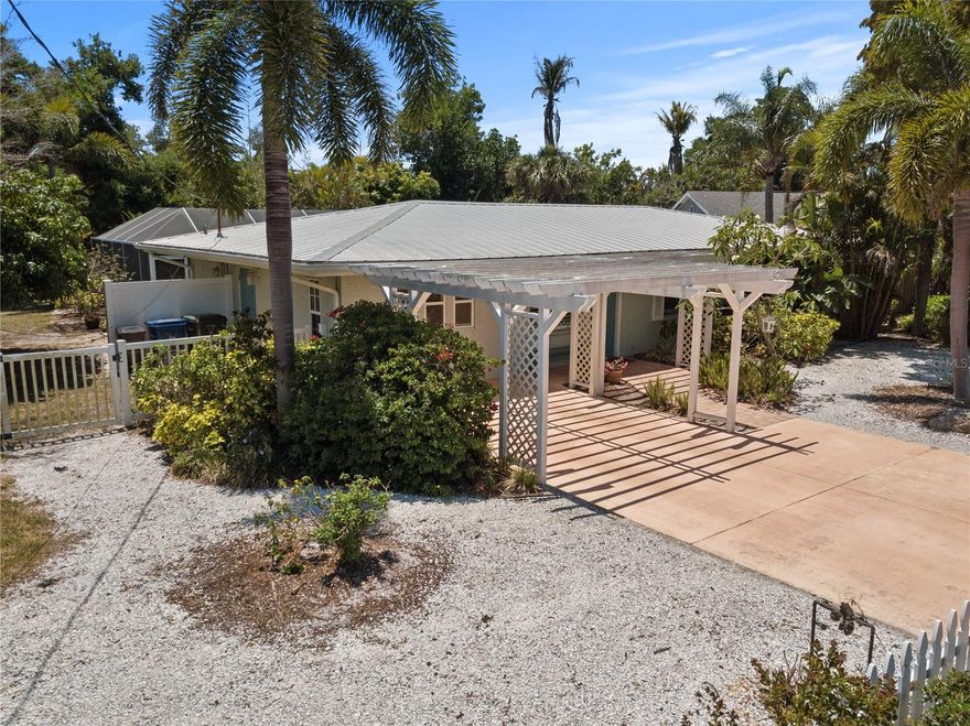 Wonderfully charming street along HIDDEN HARBOR MARINA high and dry this lovely turn key home has 3 beds and 2.5 baths, a heated pool and large fenced yard..  NO HOA Country restrictions only Sarasota County restrictions.  Home has many updates including a light and bright kitchen, window treatments, a  king bed en-suite  bath with French doors to a covered patio with plenty of lounging furniture and TV set up.  This home comes turnkey furnished and has IMPACT RESISTANT, ENERGY EFFICIENT WINDOWS AND SLIDERS and a newer metal roof. You will love this HIDDEN HARBOR neighborhood with plenty of charm. Minutes to Siesta Key shopping and dining.  A new shopping area to be completed by 2026 includes a new WHOLE FOODS and TRADER JOES as well as shopping and dining.