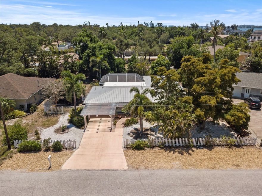 Wonderfully charming street along HIDDEN HARBOR MARINA high and dry this lovely turn key home has 3 beds and 2.5 baths, a heated pool and large fenced yard..  NO HOA Country restrictions only Sarasota County restrictions.  Home has many updates including a light and bright kitchen, window treatments, a  king bed en-suite  bath with French doors to a covered patio with plenty of lounging furniture and TV set up.  This home comes turnkey furnished and has IMPACT RESISTANT, ENERGY EFFICIENT WINDOWS AND SLIDERS and a newer metal roof. You will love this HIDDEN HARBOR neighborhood with plenty of charm. Minutes to Siesta Key shopping and dining.  A new shopping area to be completed by 2026 includes a new WHOLE FOODS and TRADER JOES as well as shopping and dining.