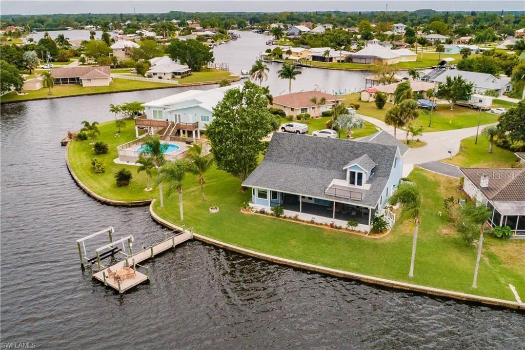 A Stunning Riverfront home. This gorgeous home sits at the end of a point, providing breathtaking 180 views. Watch the manatees and dolphins swimming by from your patio, only steps away from the river. The balcony upstairs offers a glimpse of the picturesque scenery–have a look at the pictures for yourself! This house requires no updating, as all of the bathrooms, plumbing and impact windows have been recently installed. Each bedroom boasts its own bath, with one downstairs and two upstairs. The master bath is especially luxurious; with custom cabinets and granite countertops, designer tile, and a freestanding soaking tub. Bifold stained shutters open at the tub, offering a breathtaking view of the river. The kitchen and pantry are adorned with Quartzite stone countertops and a marble backsplash, along with brand new appliances. Downstairs, the floors are made of elegant 7 1/2” wide European White Oak. A composite dock and boat lift are ready for your boat. There is even room for a Pool and RV! This home offers furnishings negotiable with sale giving you the opportunity to tailor it to your preferences and lifestyle. As you approach the house, you'll be greeted by a large relaxing columned porch and elegant double doors that say, "Welcome home."