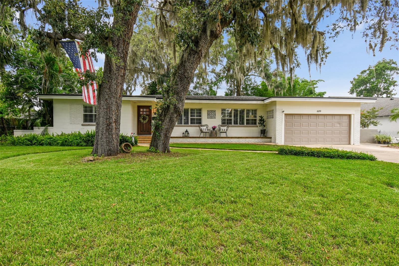 Introducing 609 Lake Shore Drive, a captivating 3-bedroom, 3-bathroom residence offering over 2,000 square feet of elegant living in the coveted Maitland area. This pristine home combines the best of modern comfort and timeless design, with a location that places you just minutes from Winter Park, Downtown Orlando, and Altamonte Springs, providing an unrivaled lifestyle of convenience.
Step inside to experience gleaming hardwood floors, custom plantation shutters, and an abundance of natural light flooding the elegant Florida room, a tranquil space ideal for relaxation or entertaining. The split floor plan ensures both privacy and seamless flow, enhanced by a freshly painted interior that complements the home’s refined aesthetic.
The primary suite serves as a private sanctuary, complete with a spacious walk-in closet and serene views of the expansive grounds. Modern conveniences abound, including a two-car garage, 2021 A/C system, and a 2014 roof, ensuring peace of mind for years to come.
Outdoors, the oversized backyard is your personal oasis, offering plenty of room for a pool, outdoor living spaces, or private gardens. Best of all, this home provides access to Lake Hope, inviting you to enjoy tranquil waterfront living. A rare combination of elegance, serenity, and location—this home is a true gem, offering a lifestyle of sophistication and ease in one of Maitland’s most sought-after neighborhoods.
