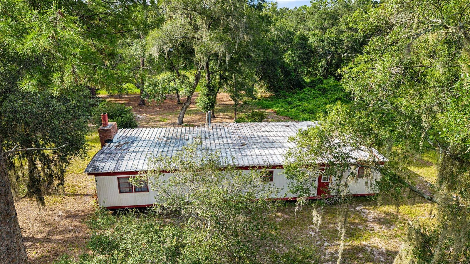 Unlock the Potential – 3 Lots, 1.04 Acres, Endless Possibilities!
The value is in the land with this unique opportunity in Ocklawaha! This listing includes a total of three lots (1.04 acres)—the main parcel at 18631 SE 106th Pl (.39 acres) features a 4-bedroom, 1.5-bath mobile home in need of major rehab or removal. Also included: adjoining parcels at 18680 SE 105th Ln (.39 acres) and a third lot (.26 acres), giving you ample space for future development, additional homesites, or a private retreat. No HOA. Convenient to Lake Weir, Ocklawaha River, and the Ocala National Forest. Whether you’re looking to build, invest, or create a homestead, this land is full of potential!